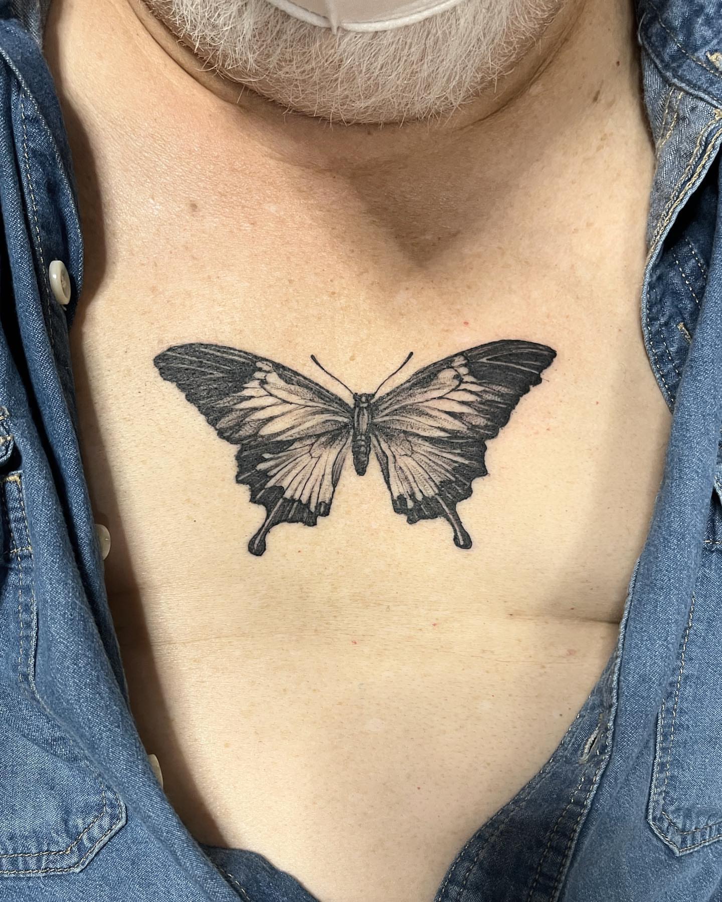 Butterfly black and grey tattoo on the chest by Sarah Spread