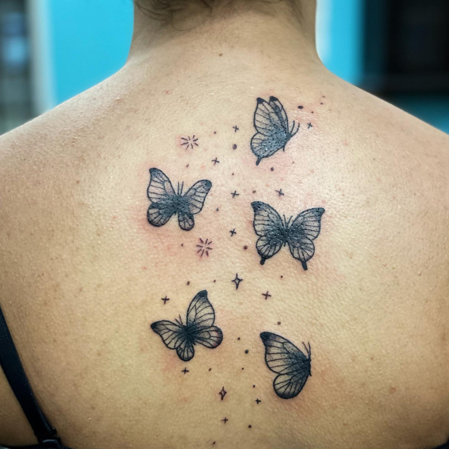 Butterflies dotwork tattoo on the back by Erin Stephens