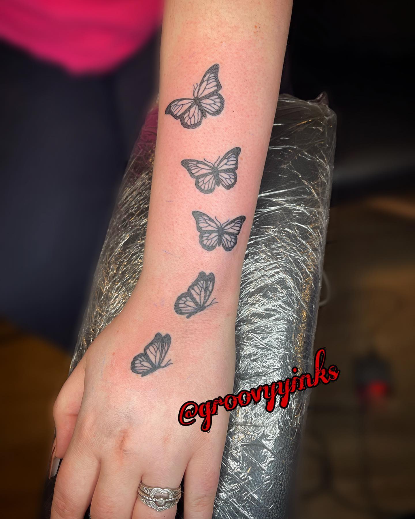 Butterflies black and grey tattoo on the upper arm by groovyyinkss