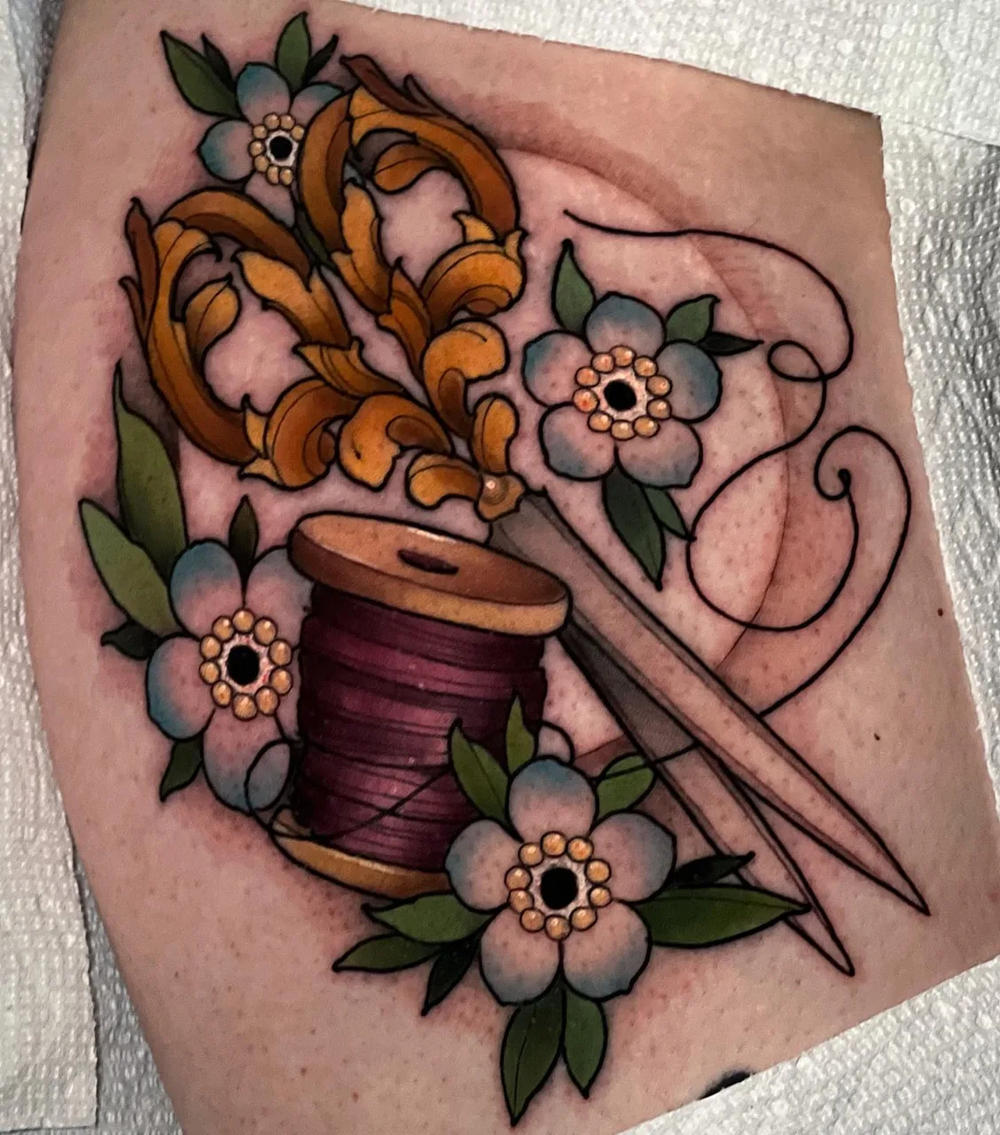 Sewing tools and flowers American traditional tattoo on the thigh by ✤ ᴋɪʀᴀ ᴋɴᴏᴡʟᴛᴏɴ ✤