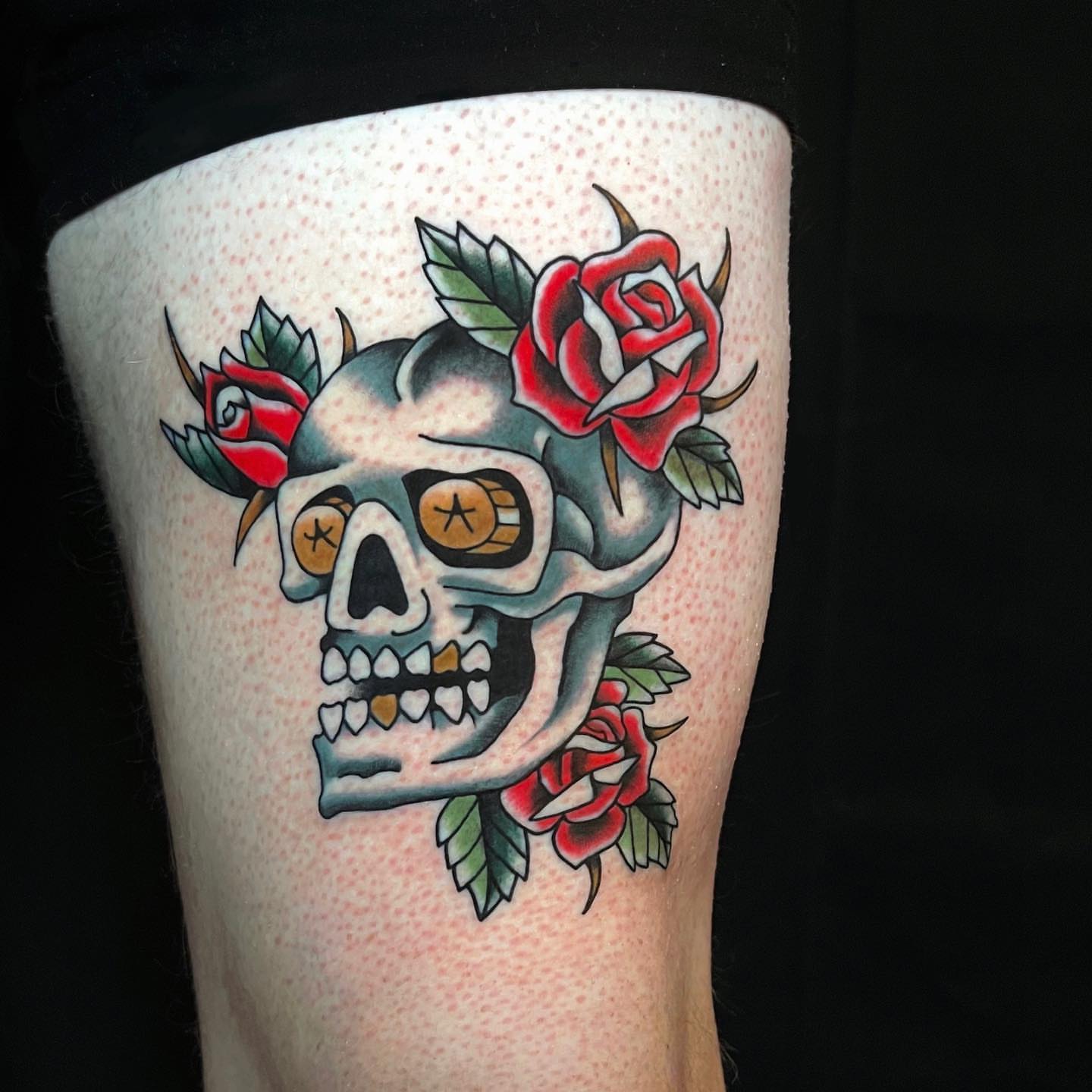 Skull with roses American traditional tattoo on the forearm by David Mendieta