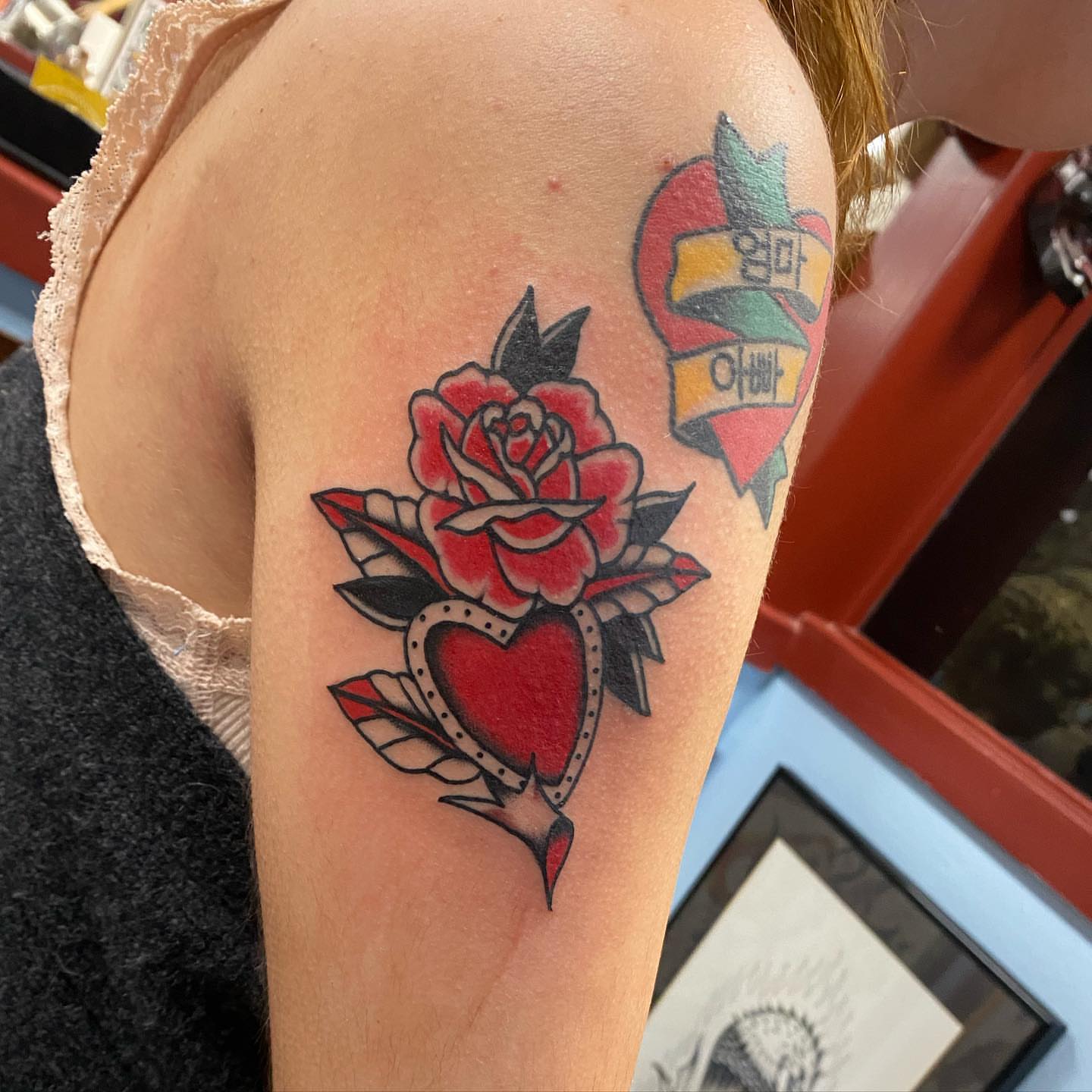 Rose and heart American traditional tattoo on the shoulder by Payton Prentice