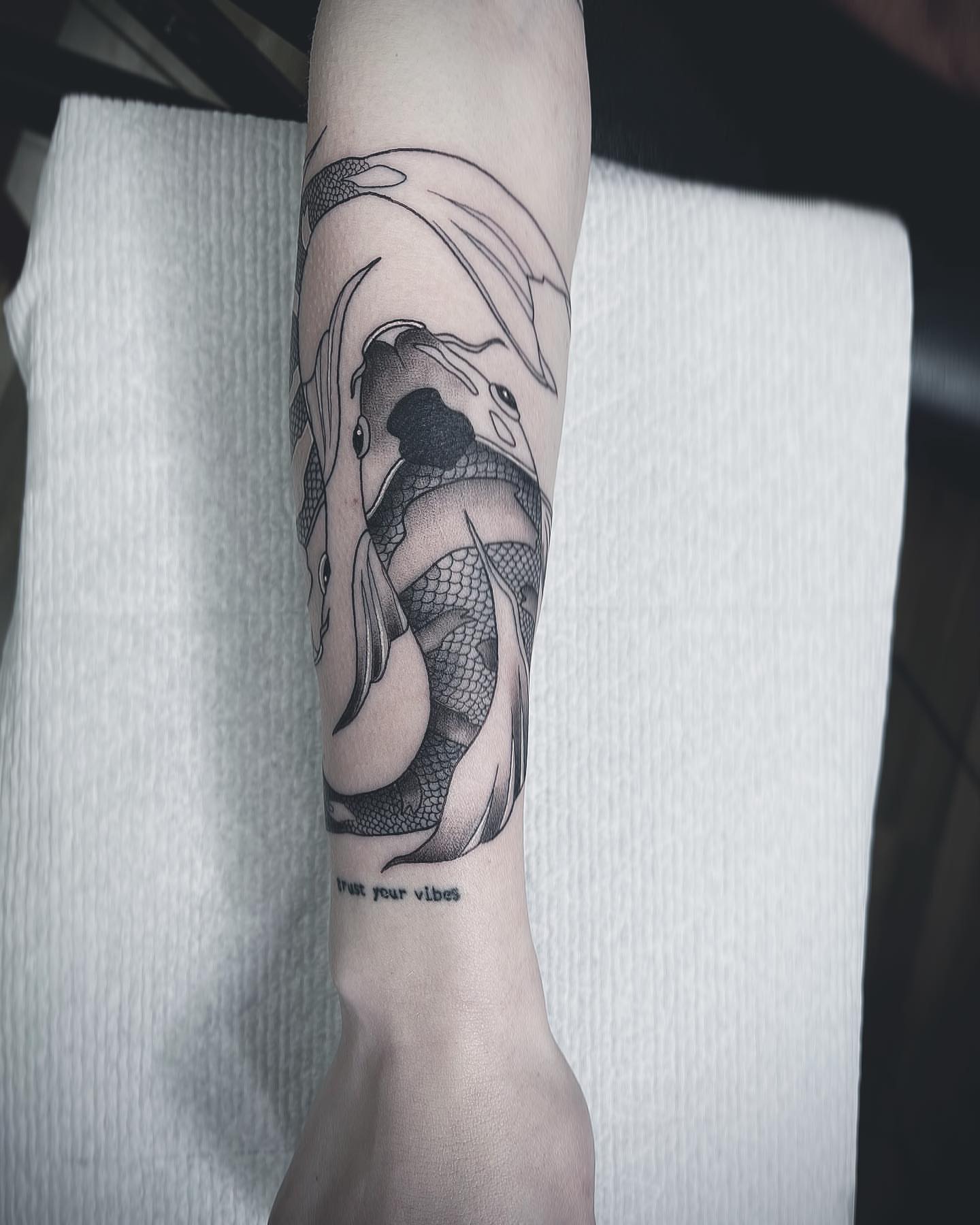 Koi fish black and grey tattoo on the forearm by Beans