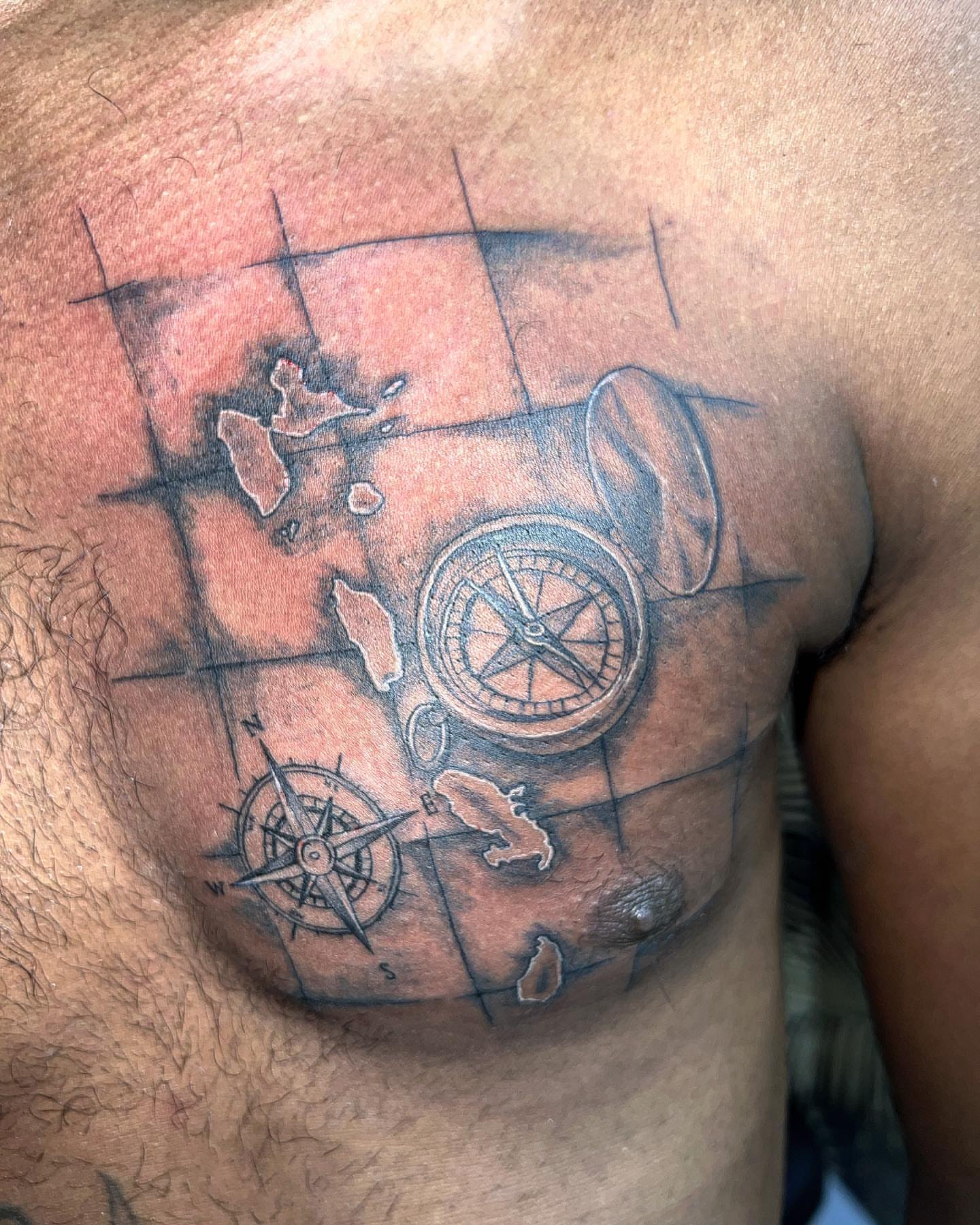 Map and compass black and grey tattoo on the chest by oxideTattoo, Morne-à-l'Eau