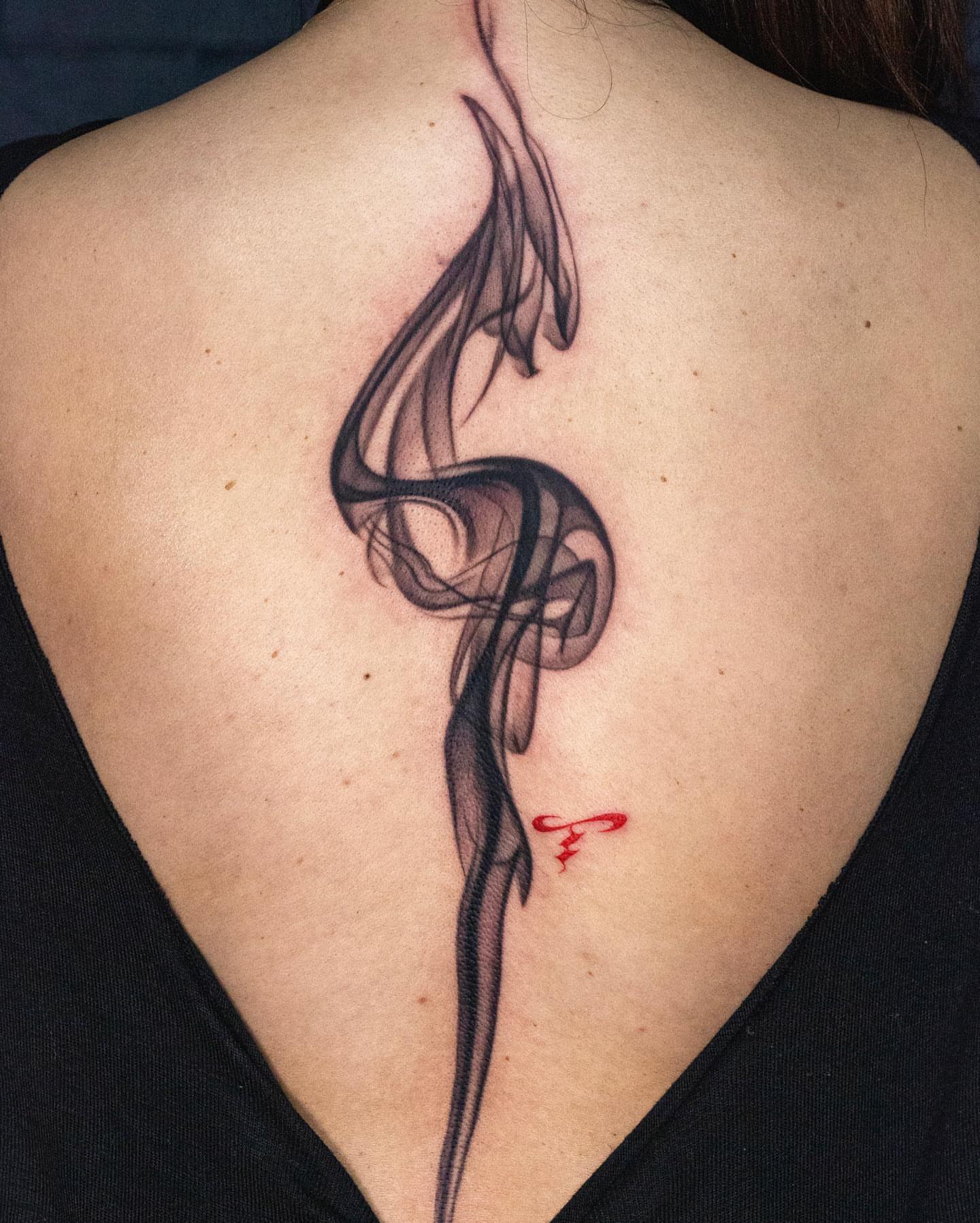 Smoke black and grey tattoo on the back by Jaime Navarro