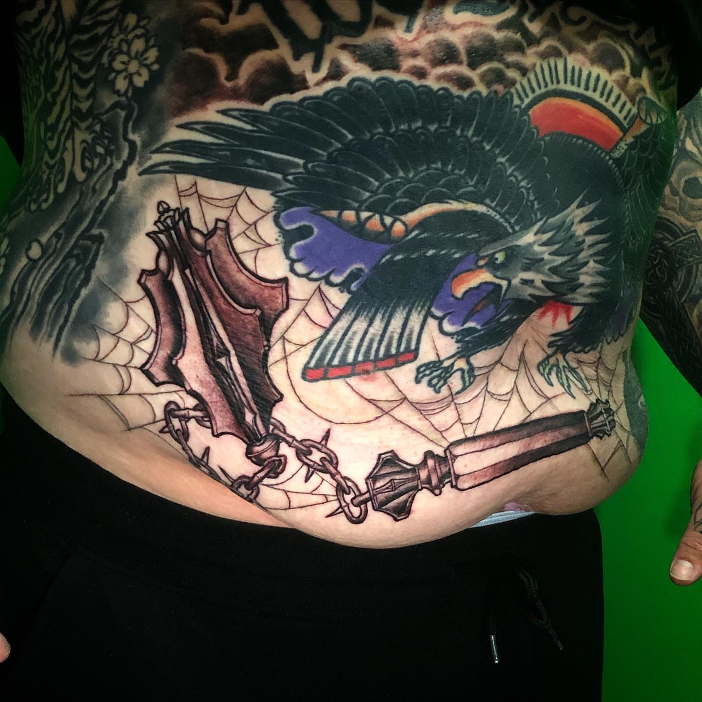 Raven and chains American traditional tattoo on the torso by Josh Green