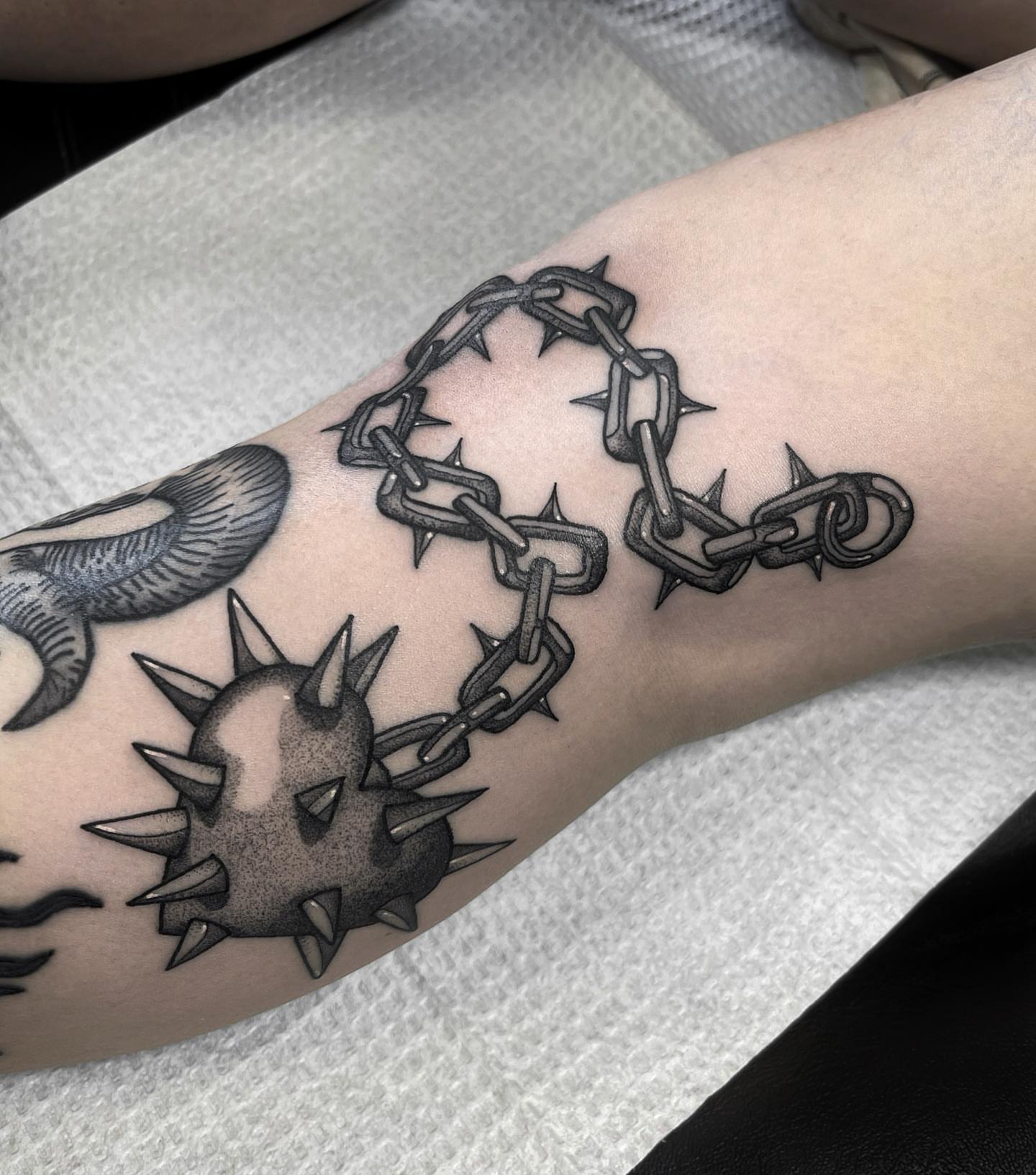 Chains and spikes black and grey tattoo on the forearm by 𝐀𝐘𝐀𝐍𝐀𝐇