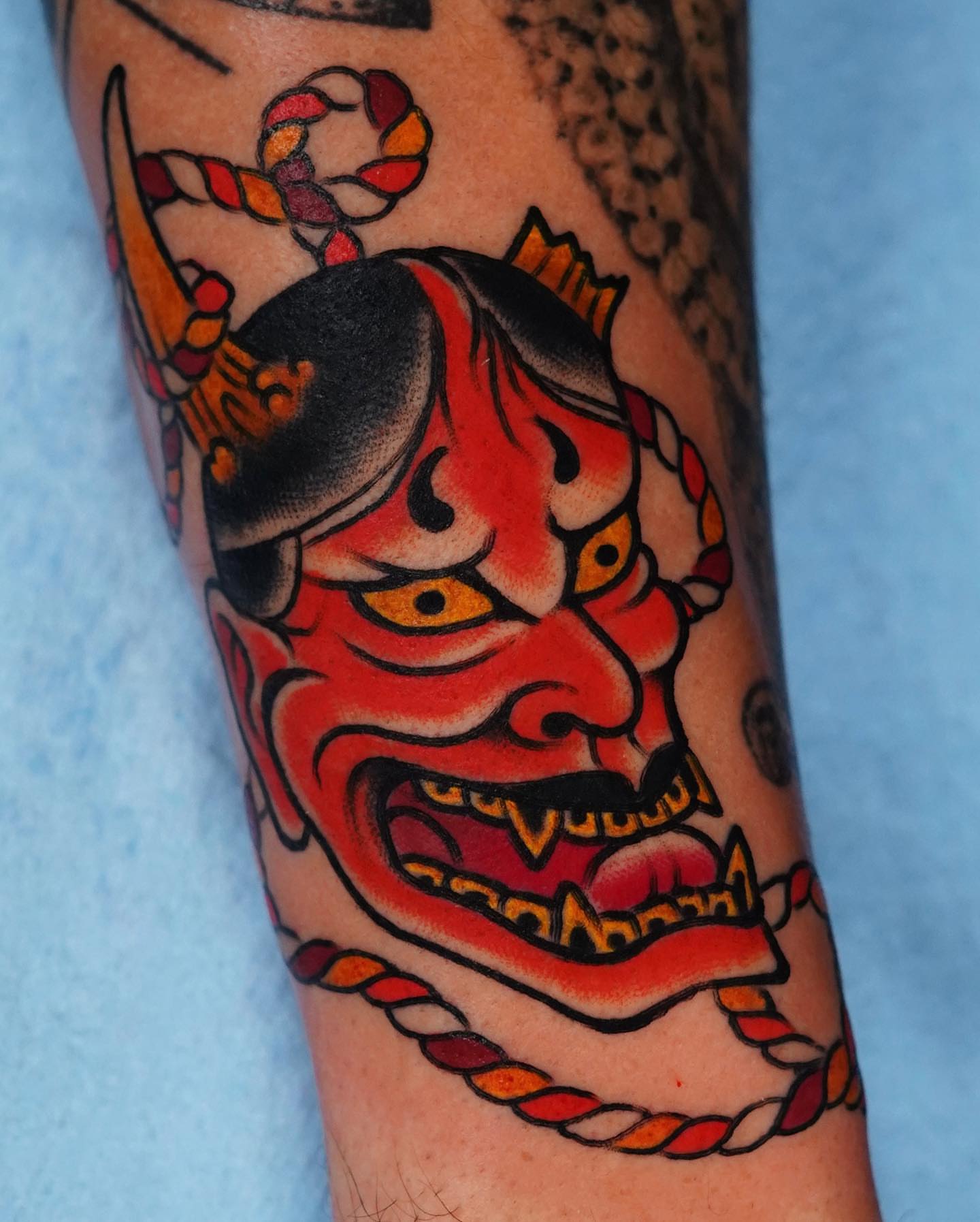 Demon mask American traditional tattoo on the forearm by Mario Arcila