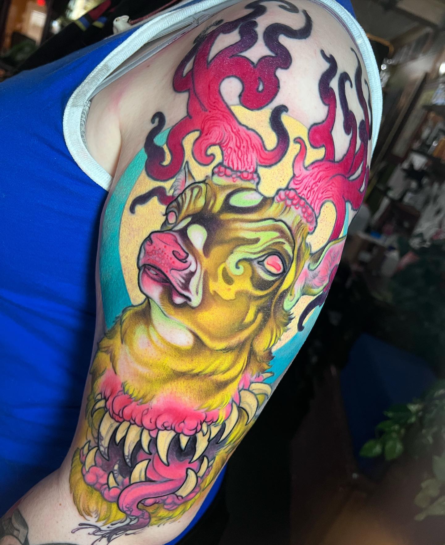 Lion with tentacles new school tattoo on the upper arm by Alisha Harding