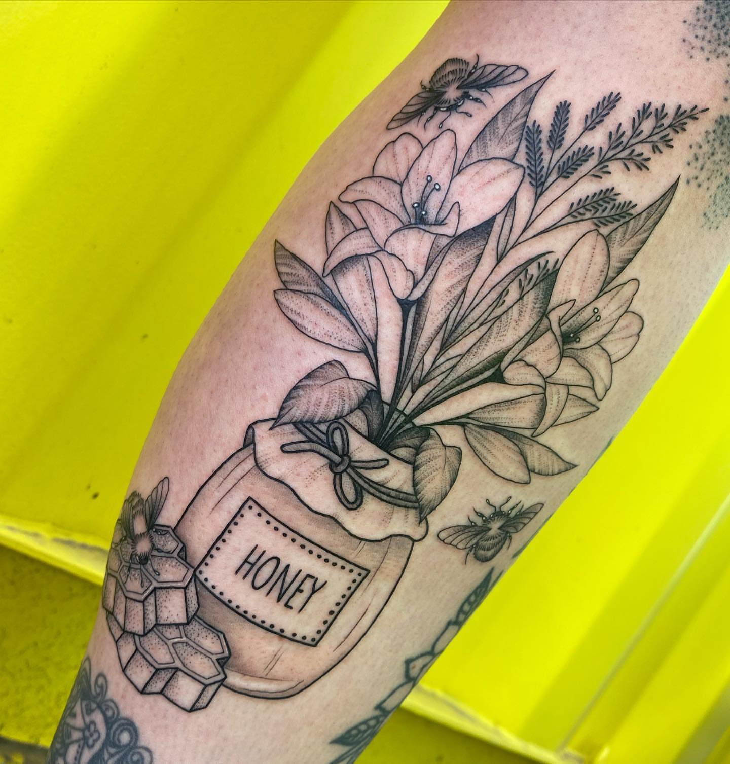 Honey jar with flowers realism tattoo on the forearm by ✨ Jaden Belle Tattoos ✨