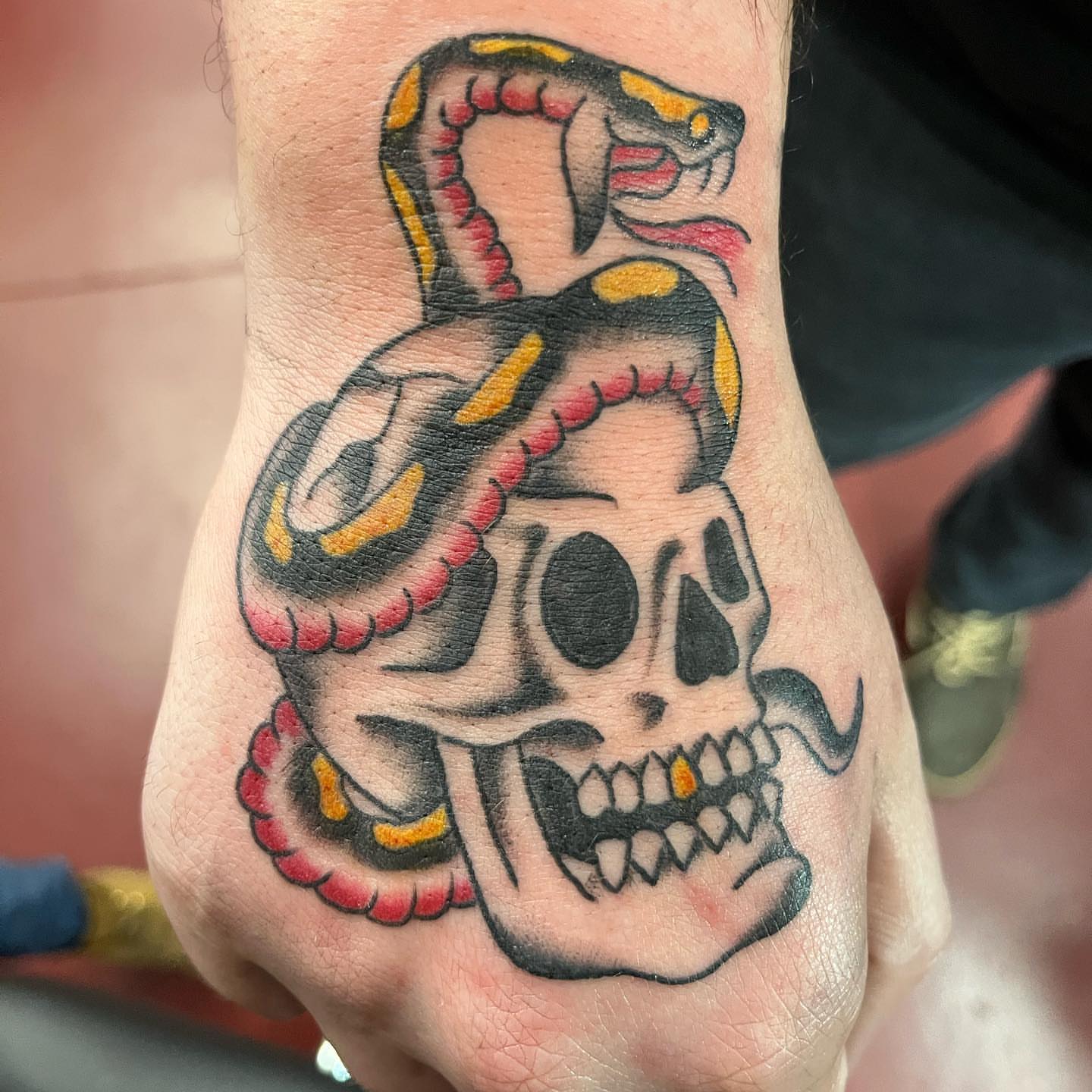 Skull and snake American traditional tattoo on the hand by IdleHandsFlex, New Orleans, Louisiana