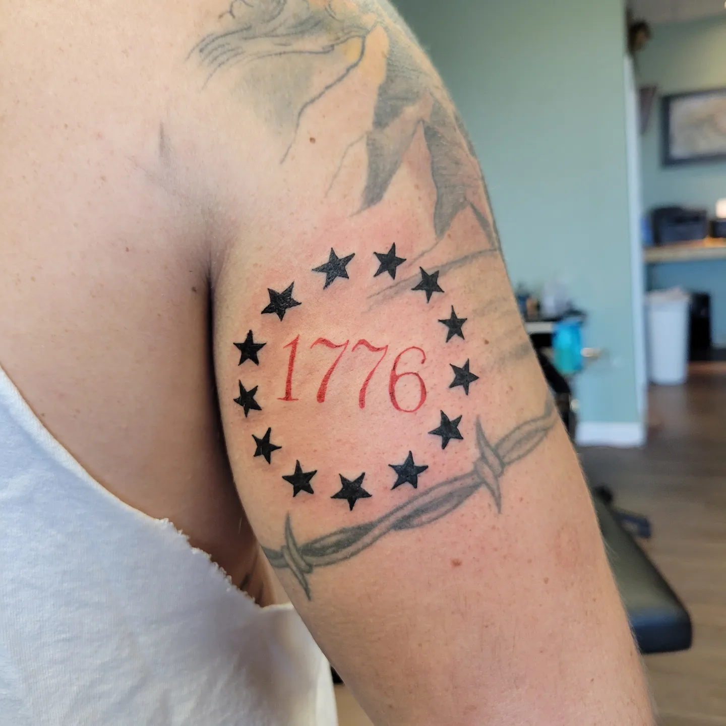 1776 American traditional tattoo on the upper arm by Nicole Bett