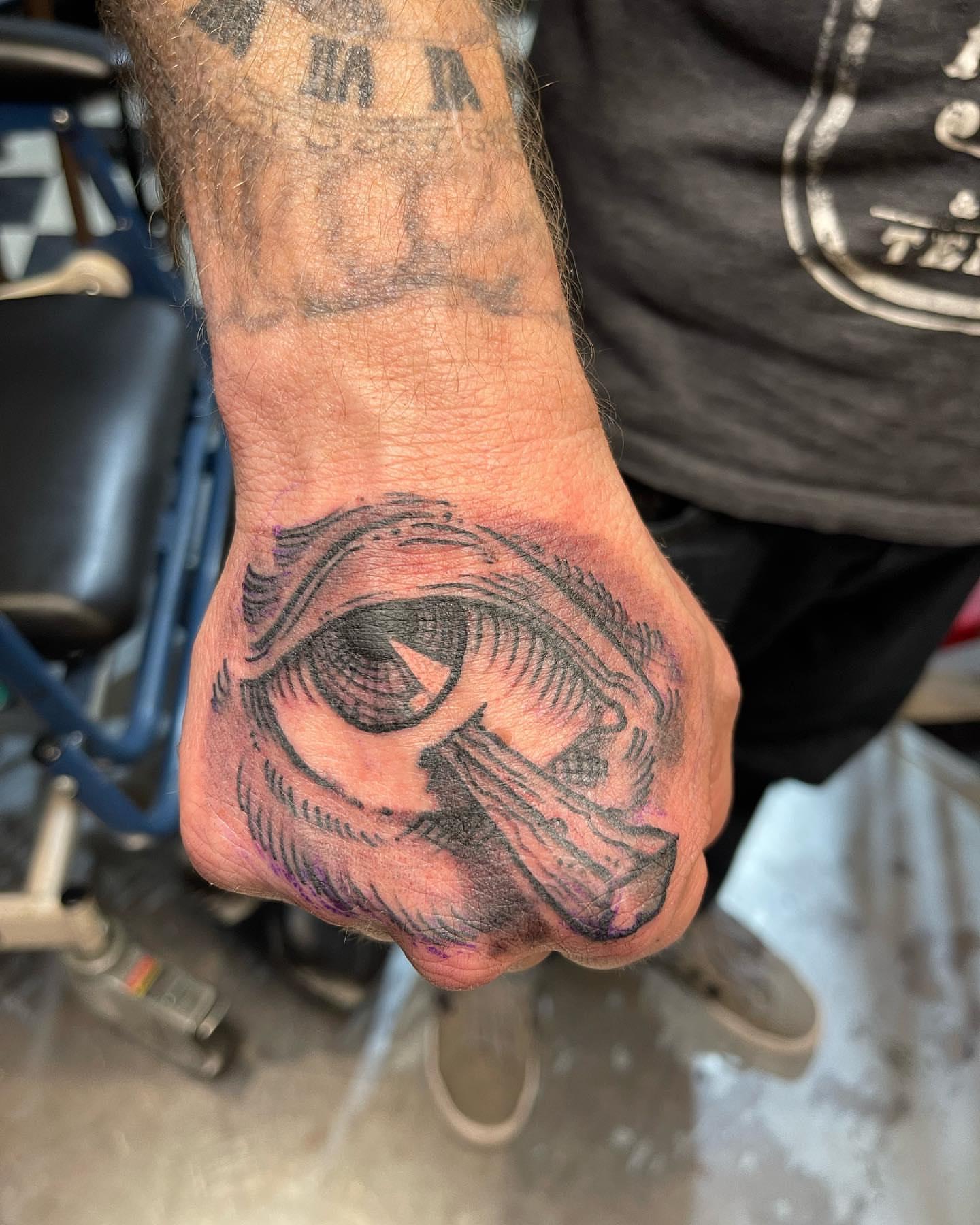 Eye black and grey tattoo on the hand by Edward Choat