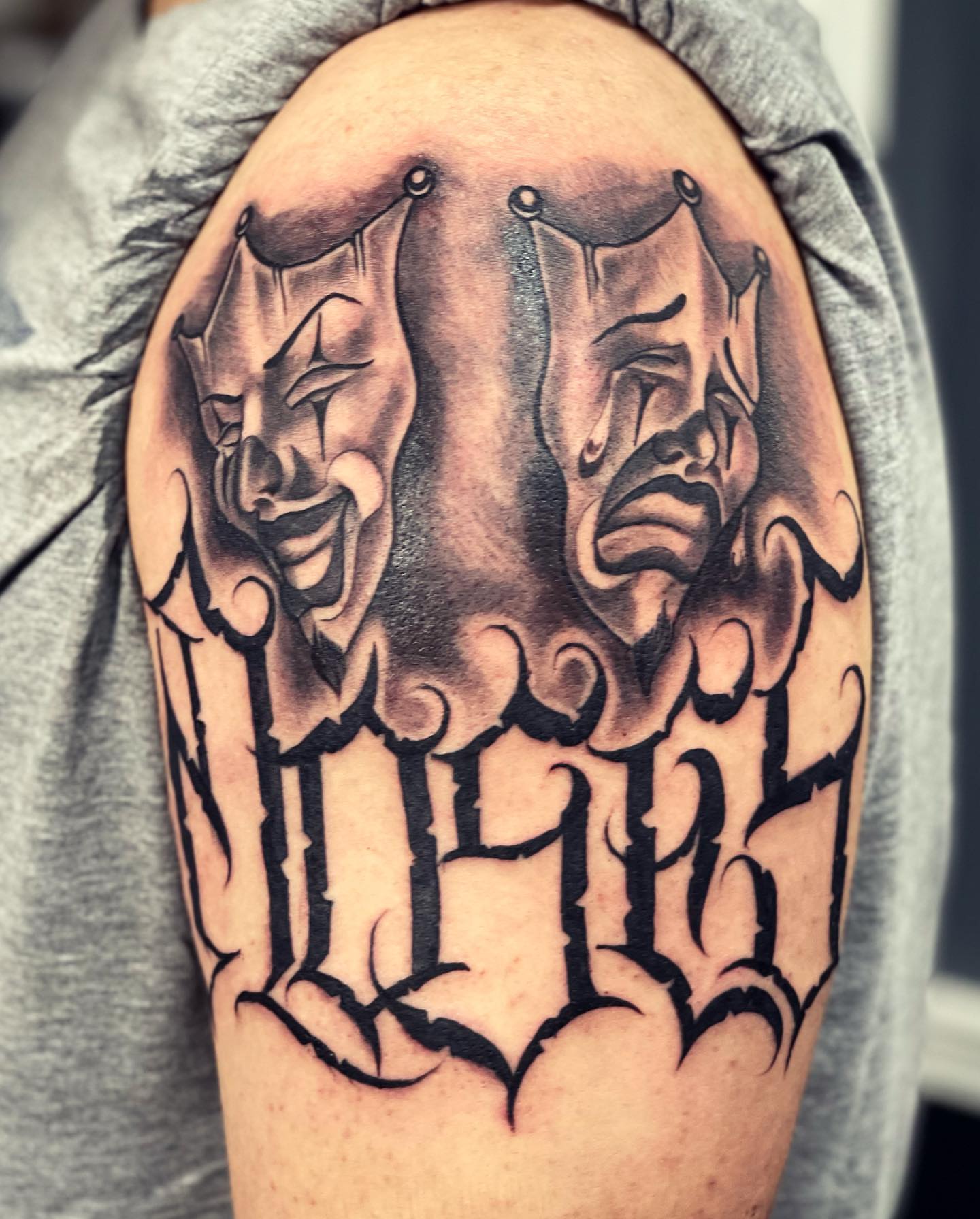 Theater masks realism tattoo on the shoulder by Peewee Morales
