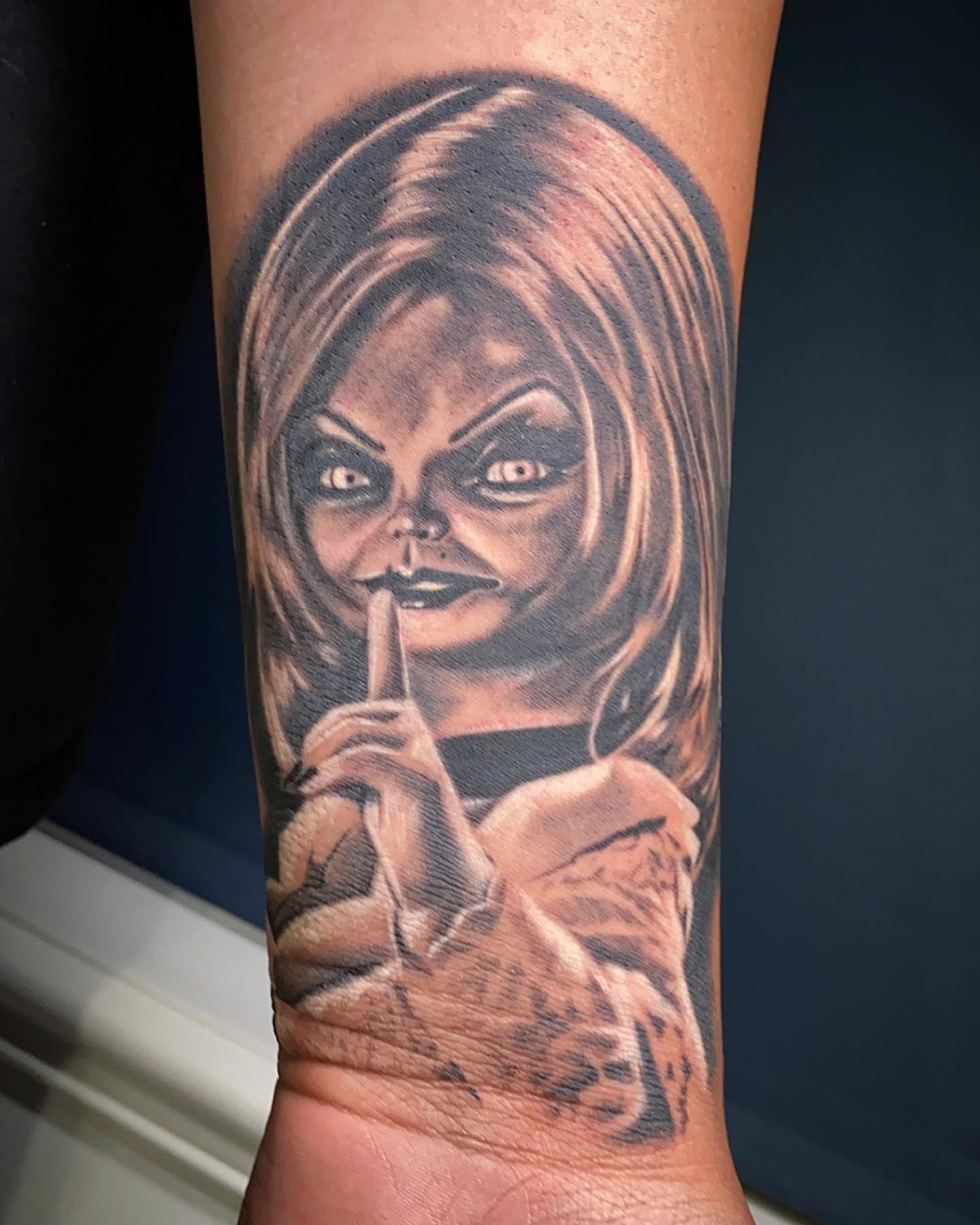 Chucky realism tattoo on the forearm by El Pato, San Jose, California