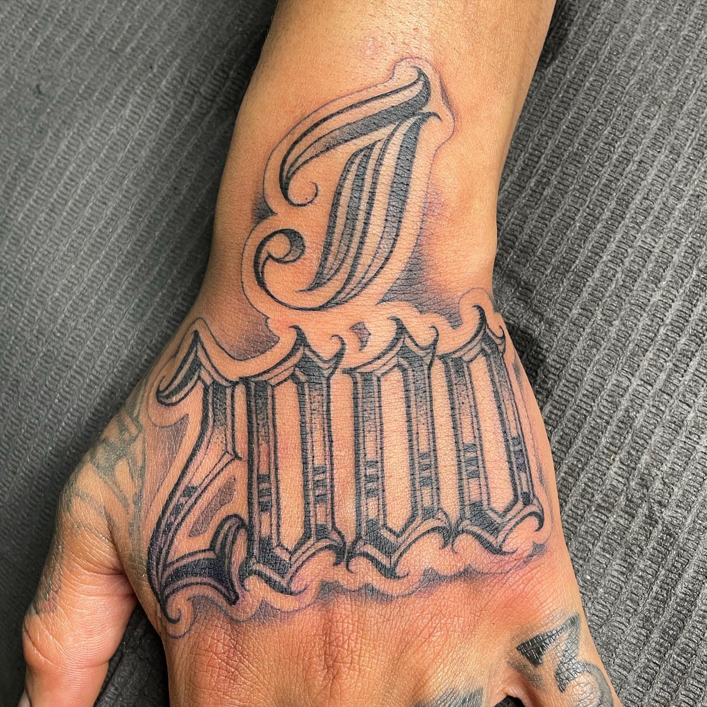 Lettering lettering script tattoo on the hand by Yari, Los Angeles, California