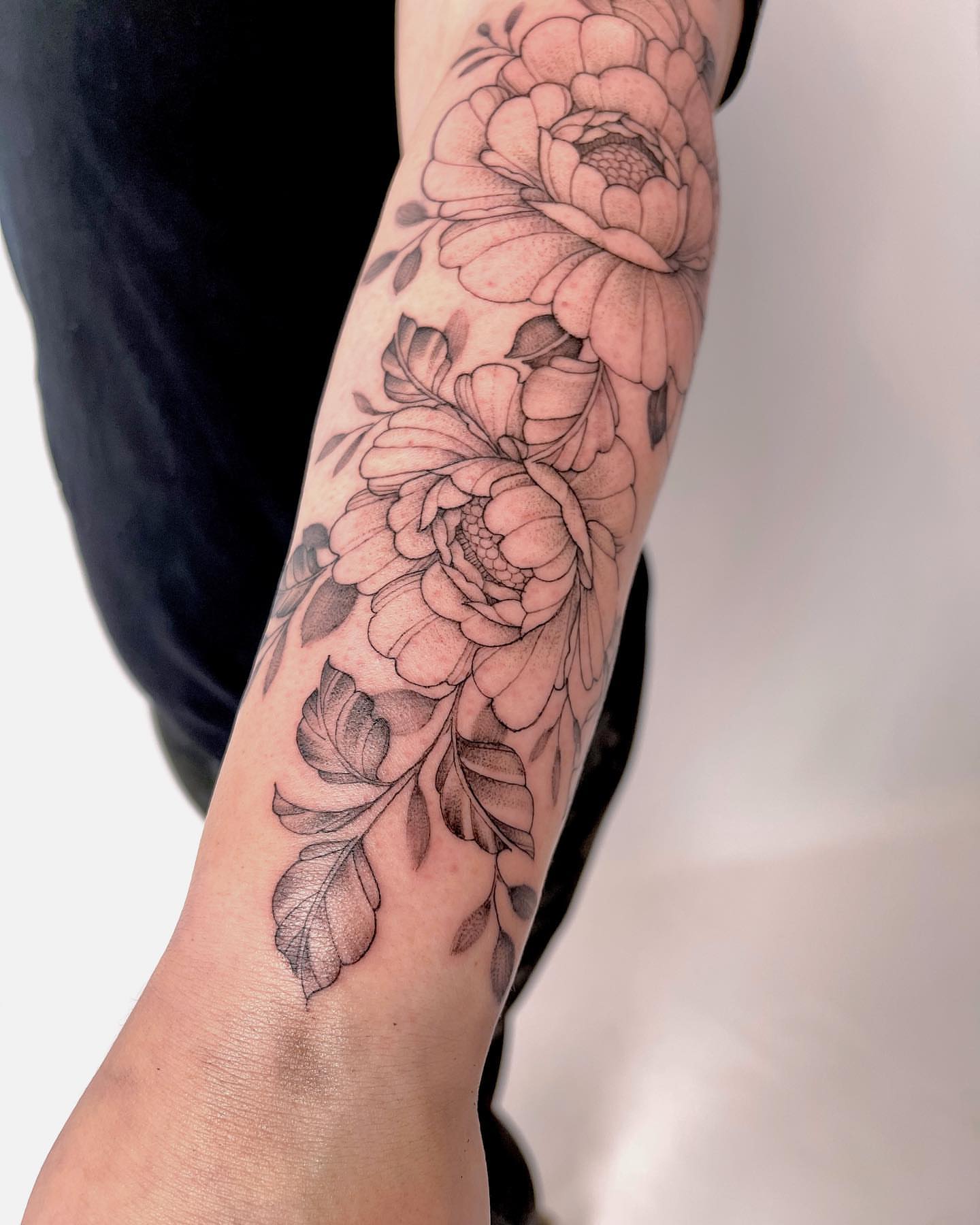 Floral arrangement black and grey tattoo on the forearm by Michigan Tattoo Artist