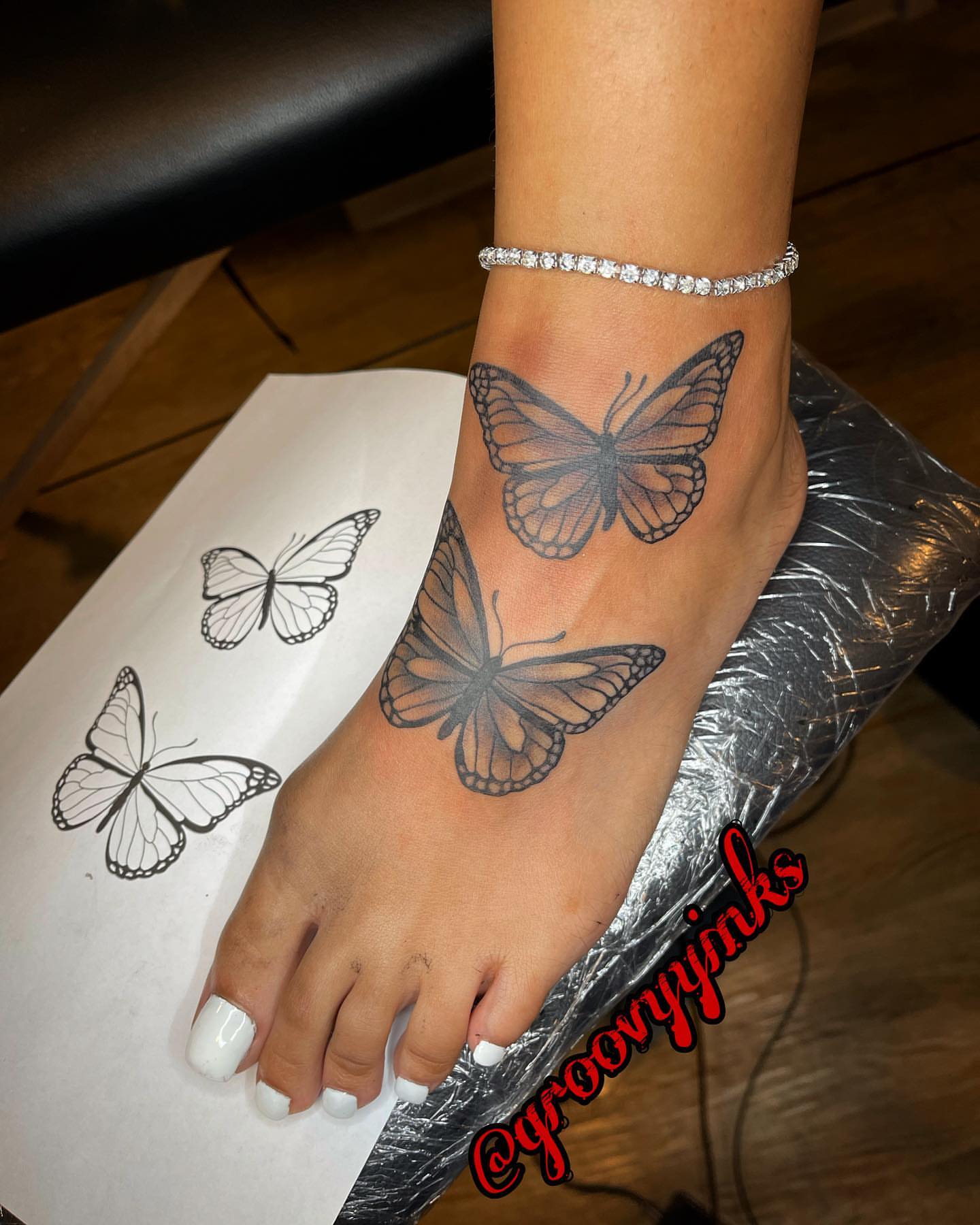 Butterfly black and grey tattoo on the foot by groovyyinkss