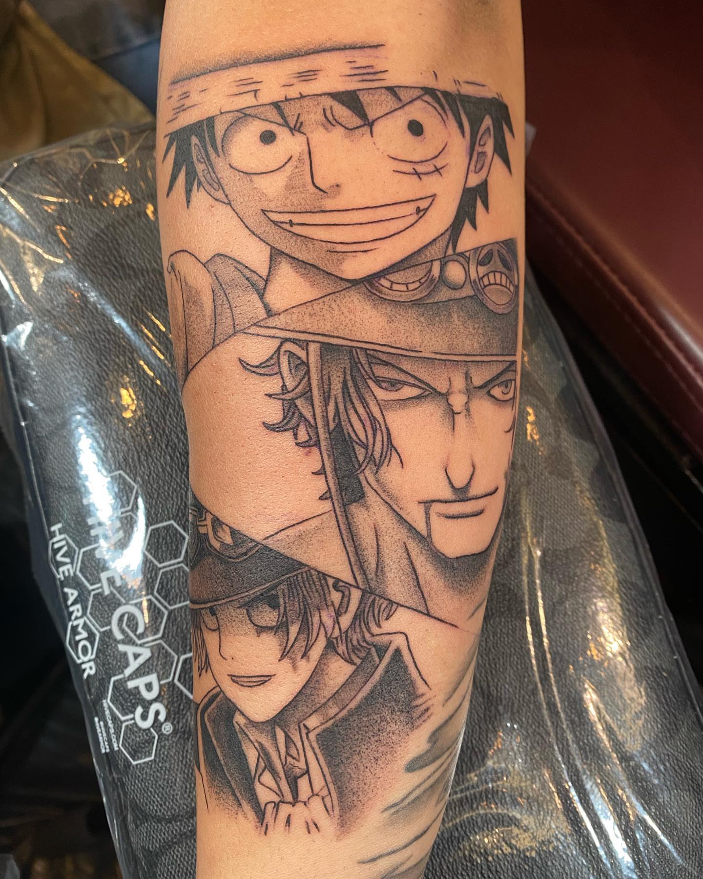 Anime characters dotwork tattoo on the forearm by Christopher Heffley
