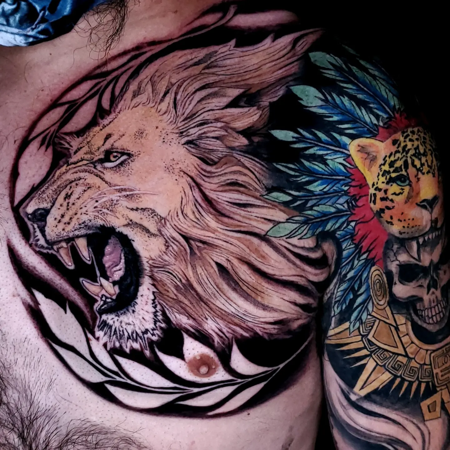 Roaring lion realism tattoo on the chest by BoogaInk