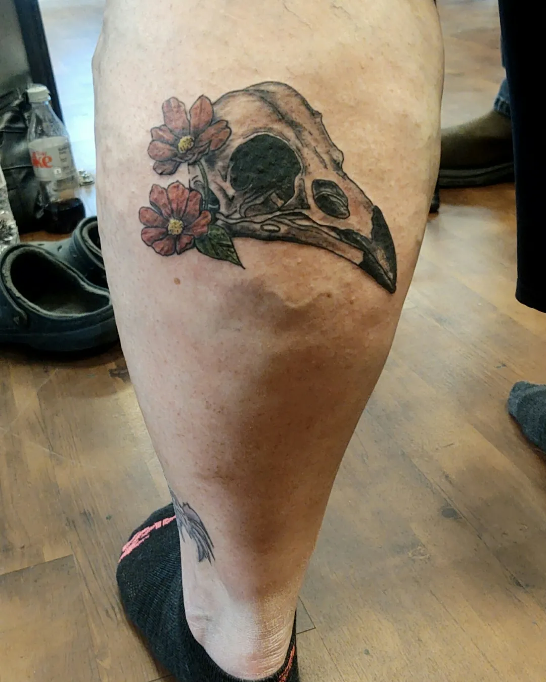 Skull and flowers realism tattoo on the calf by Madelynne