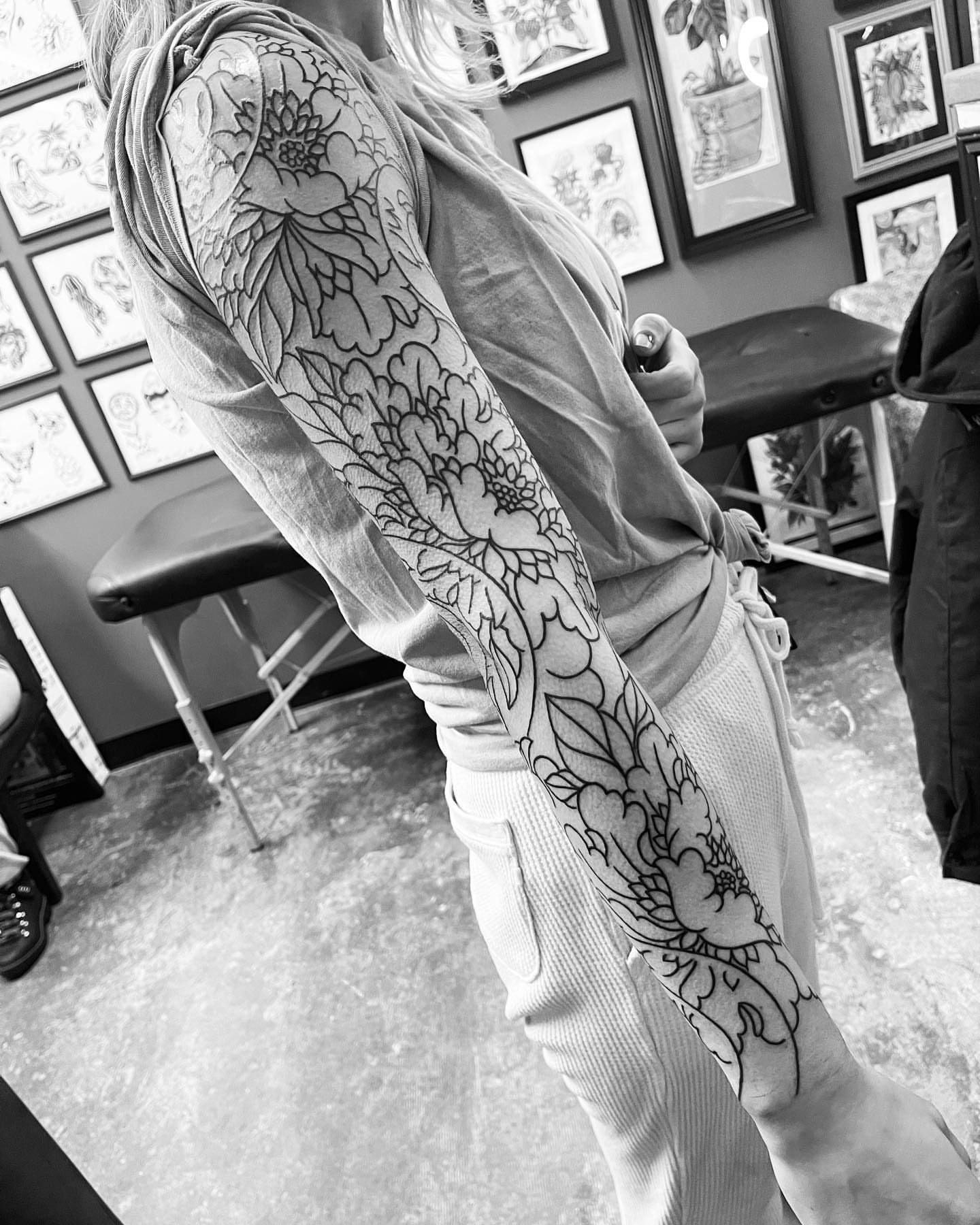 Floral sleeve black and grey tattoo on the upper arm by Chris Rogers
