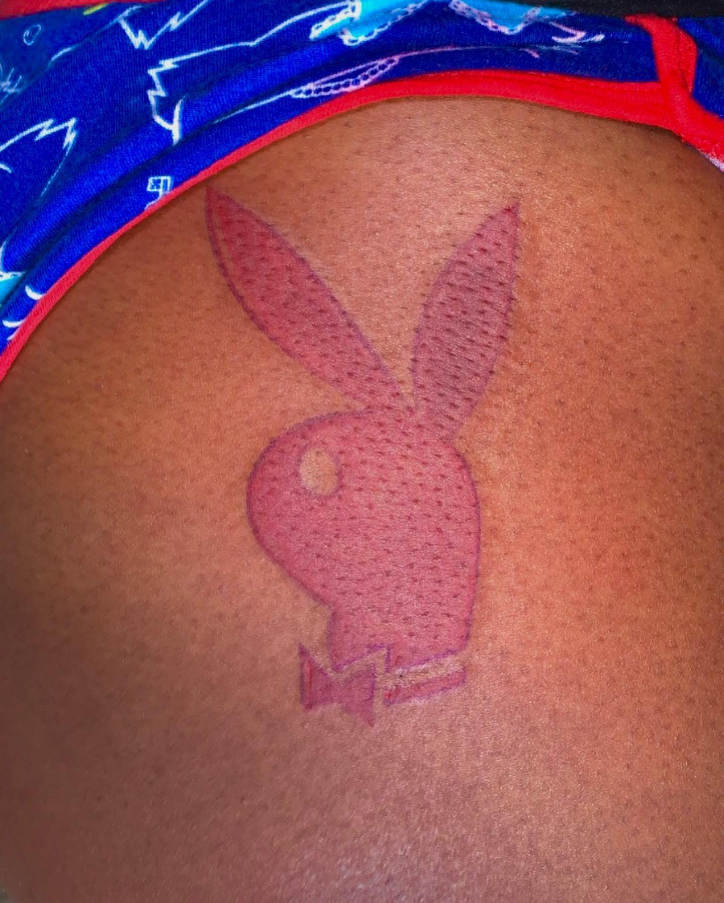 Playboy bunny dotwork tattoo on the shoulder by Evan Chastain
