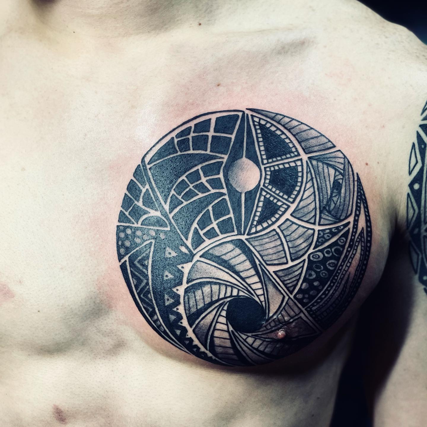 Geometric pattern geometric tattoo on the chest by Peewee Morales