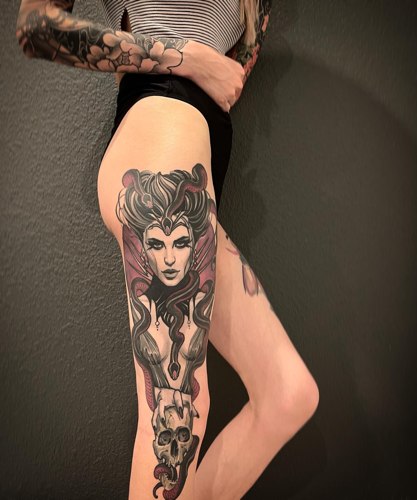 Woman with snakes American traditional tattoo on the thigh by Jeff Norton, Atascadero, California