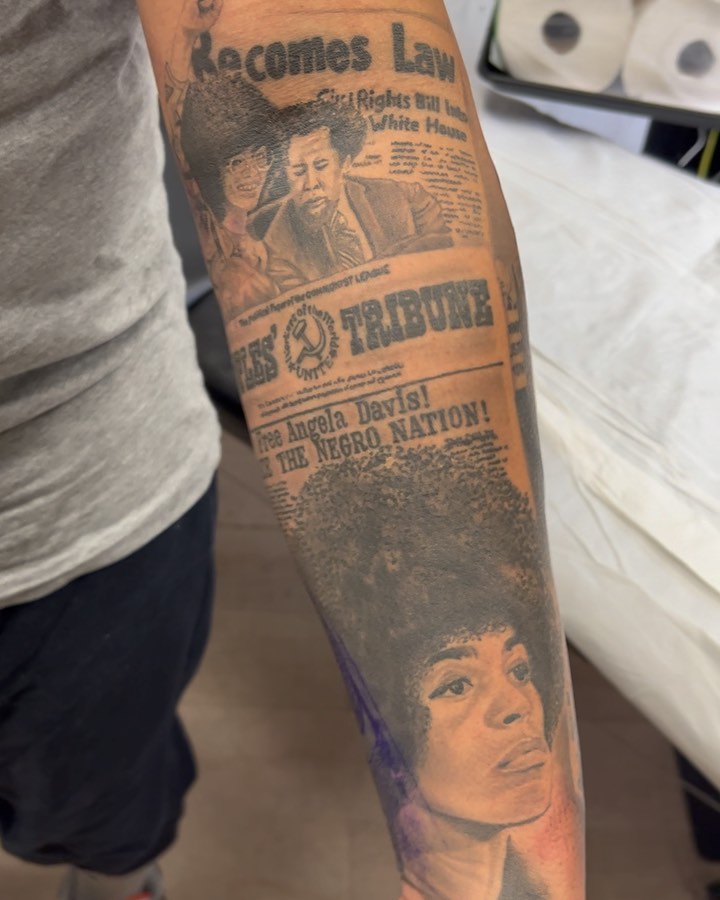 Newspaper headline black and grey tattoo on the forearm by The Tattoo Saint- DMV Tattoo Artist, Hyattsville, Maryland