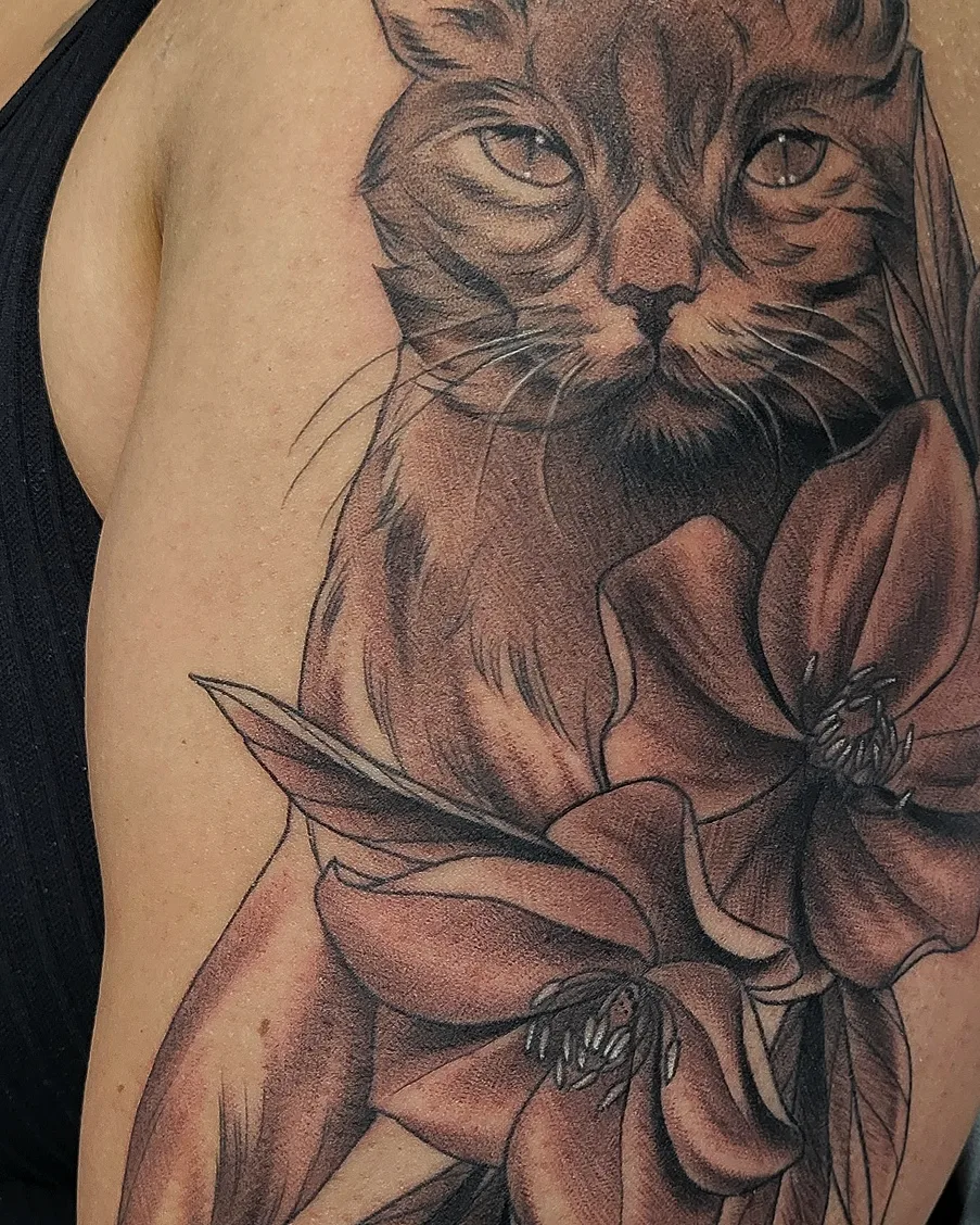 Cat with flower realism tattoo on the shoulder by @jaclyngreb