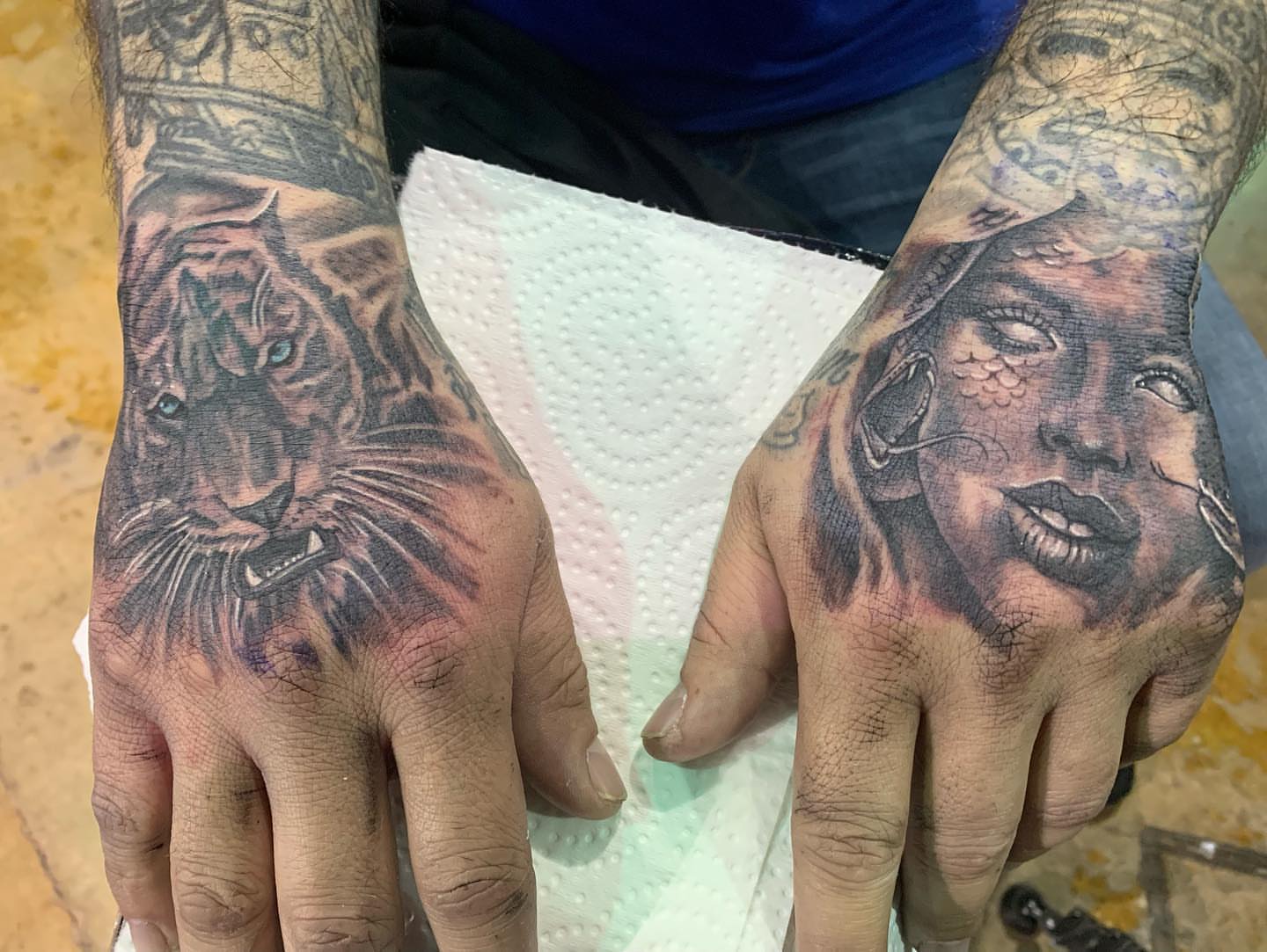 Tiger and woman realism tattoo on the hand by Daniel Illachek