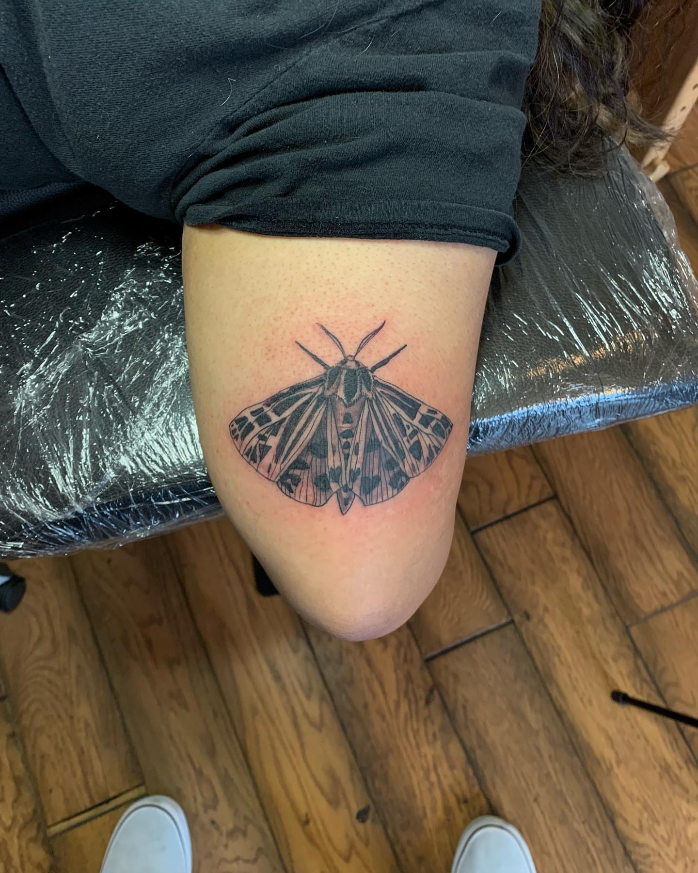 Moth black and grey tattoo on the thigh by Leo Torres