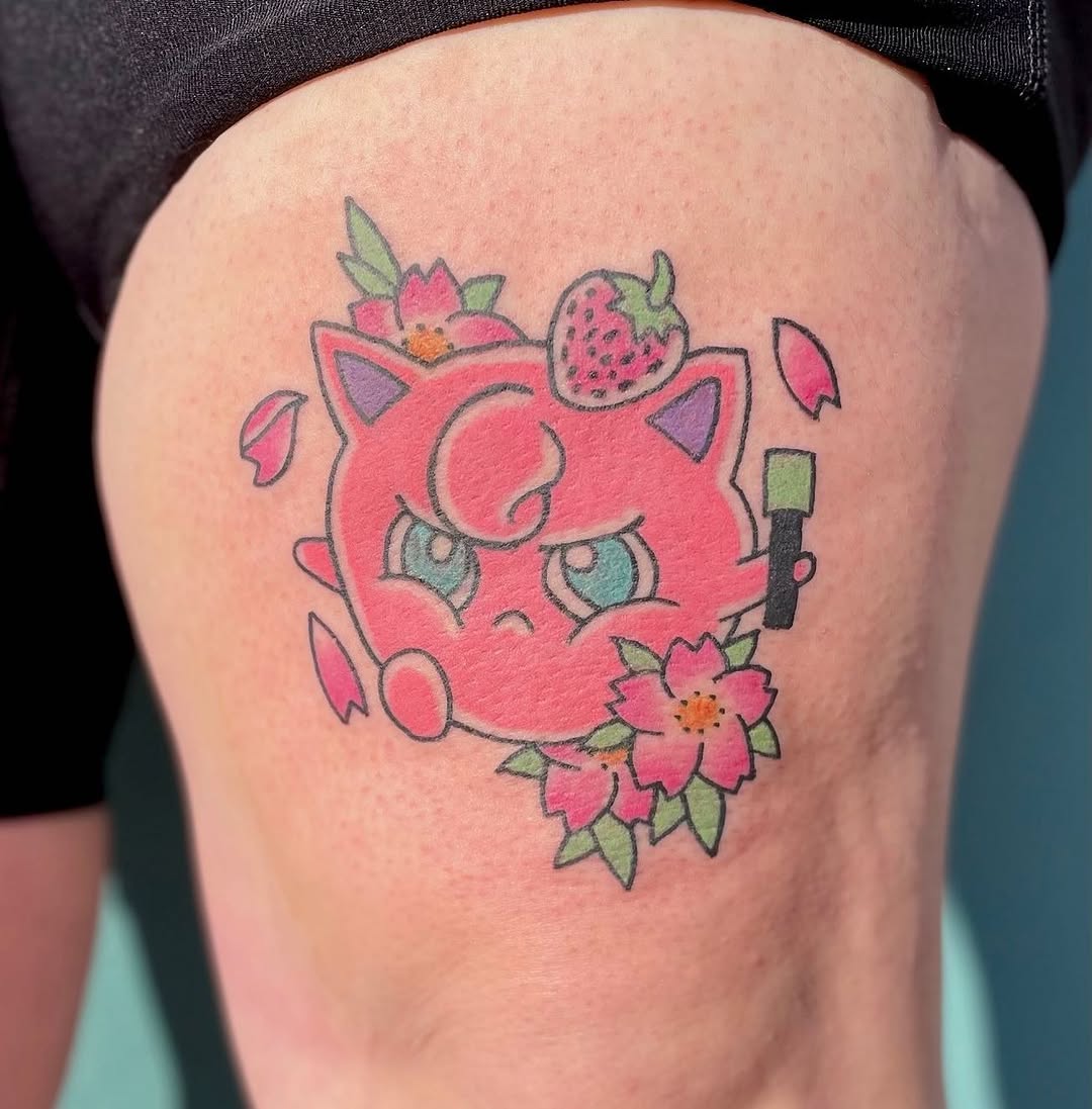 Jigglypuff with flowers and strawberry new school tattoo on the thigh by Erin Stephens