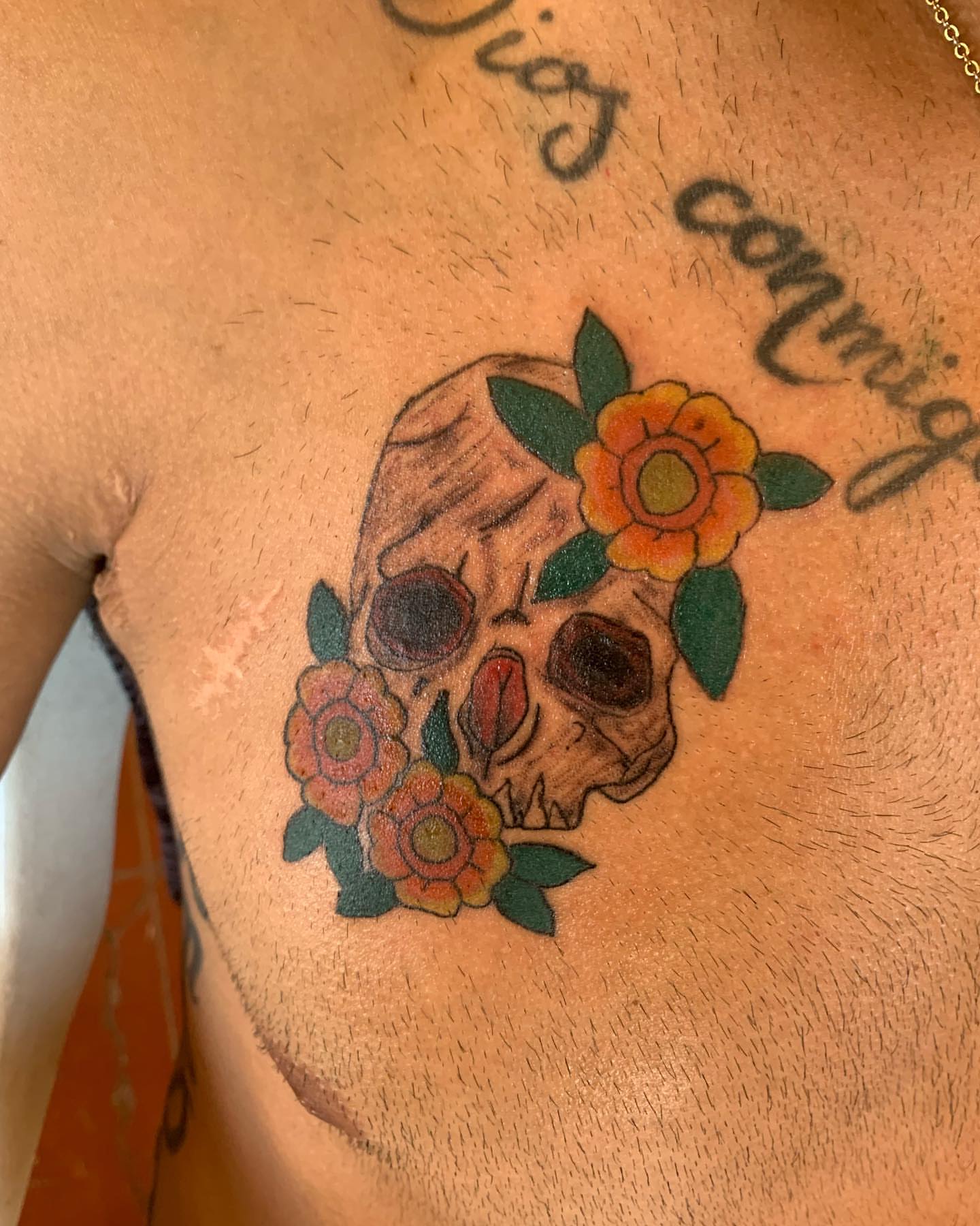 Skull with flowers American traditional tattoo on the chest by El Zepa