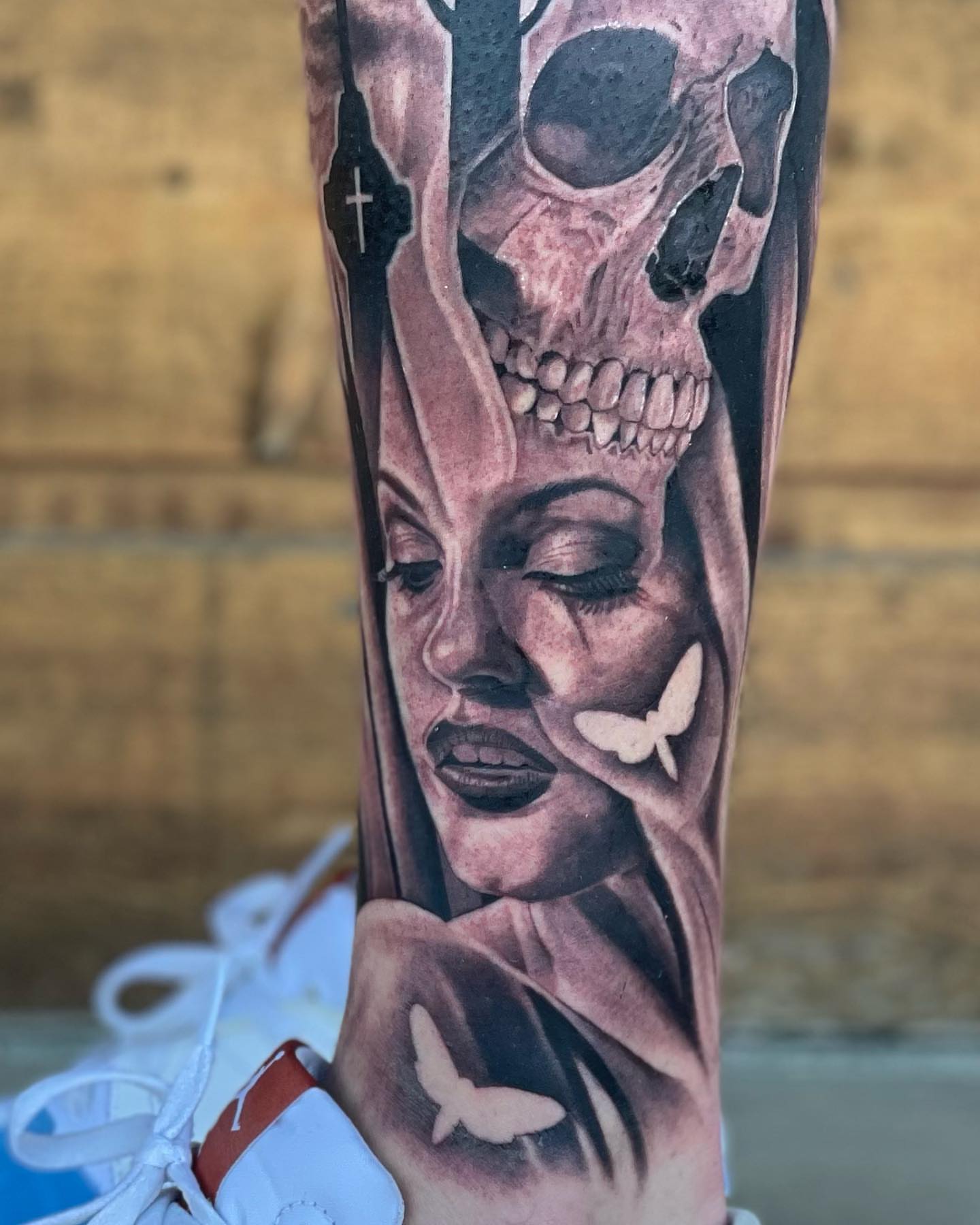 Woman with skull crown realism tattoo on the forearm by Jeremiah Warner