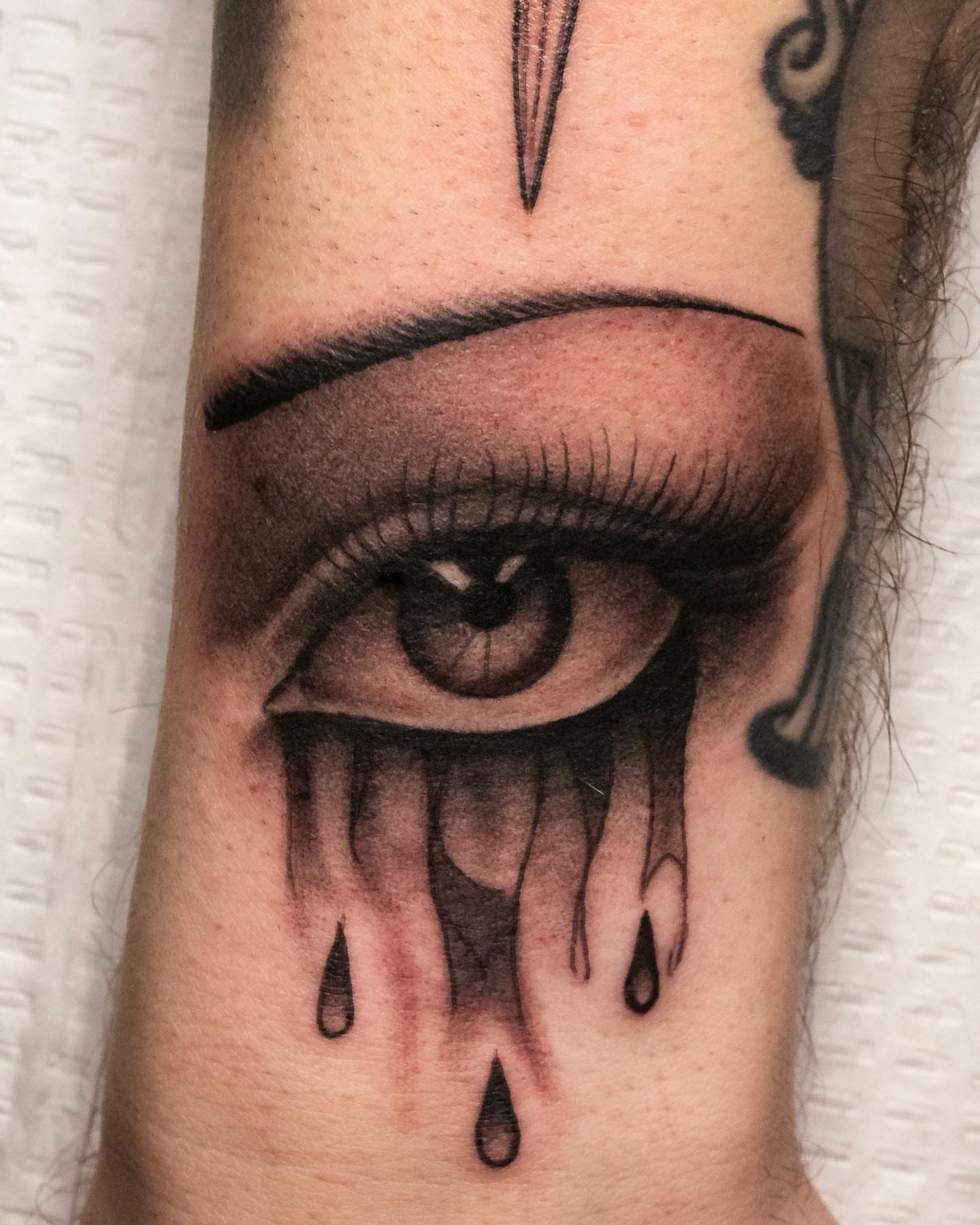 Tearful eye realism tattoo on the forearm by Jaime Navarro