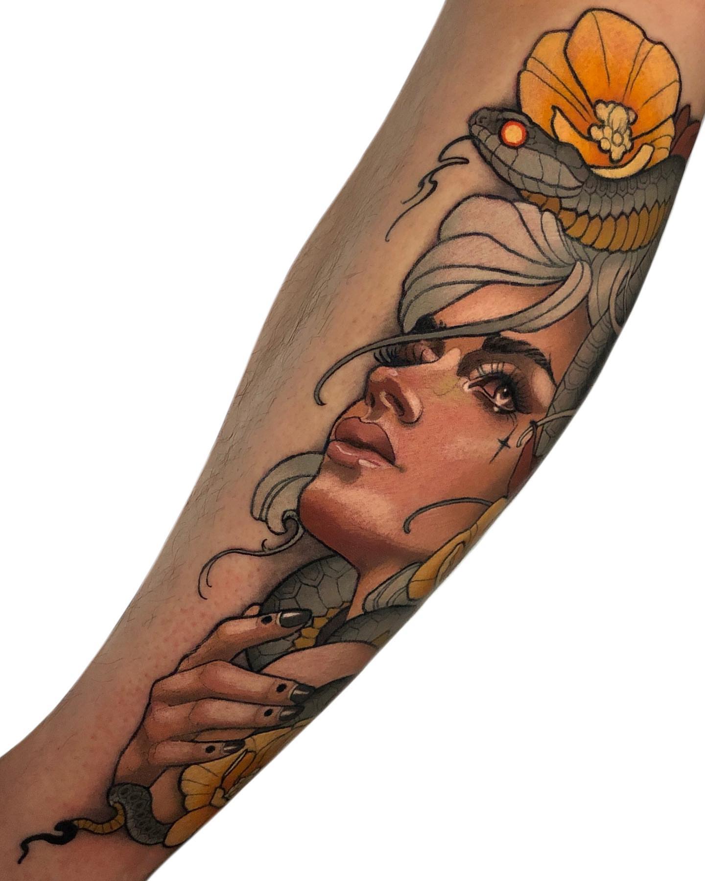 Woman with snake realism tattoo on the forearm by Levi Murphy