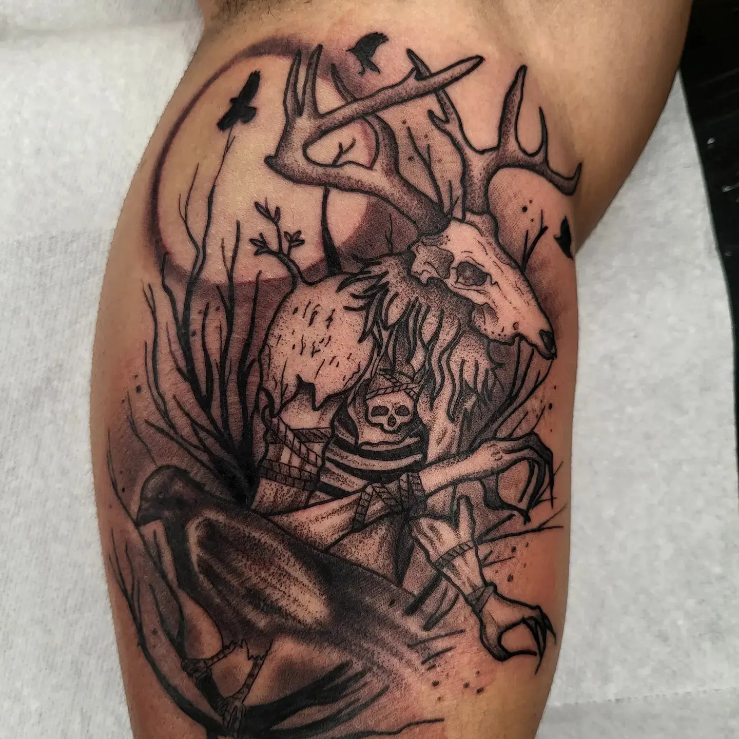 Deer skull and crow dark realism tattoo on the thigh by TattoosbyPhatboi