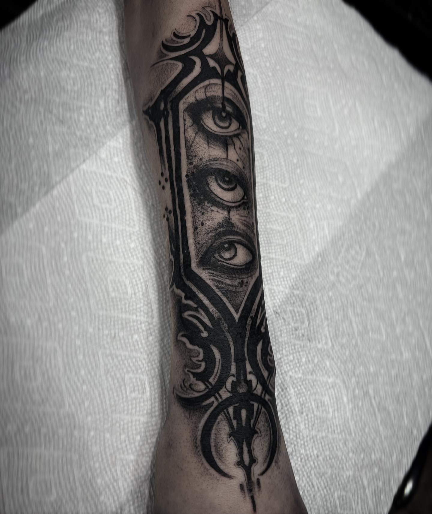 Eye and geometric patterns dotwork tattoo on the forearm by Briana Walker
