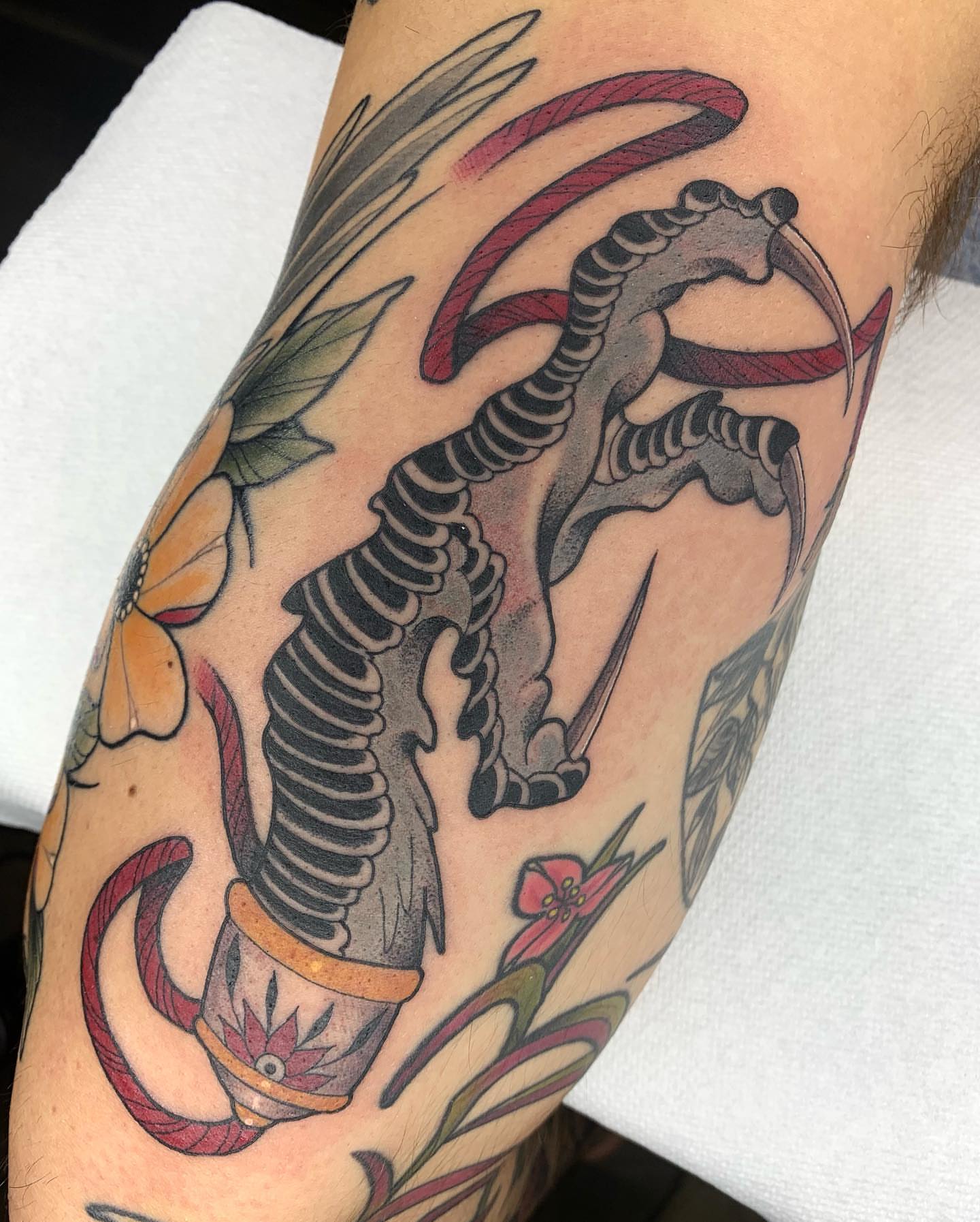 Dragon and flowers American traditional tattoo on the forearm by Luis Torres, Harrison, New Jersey