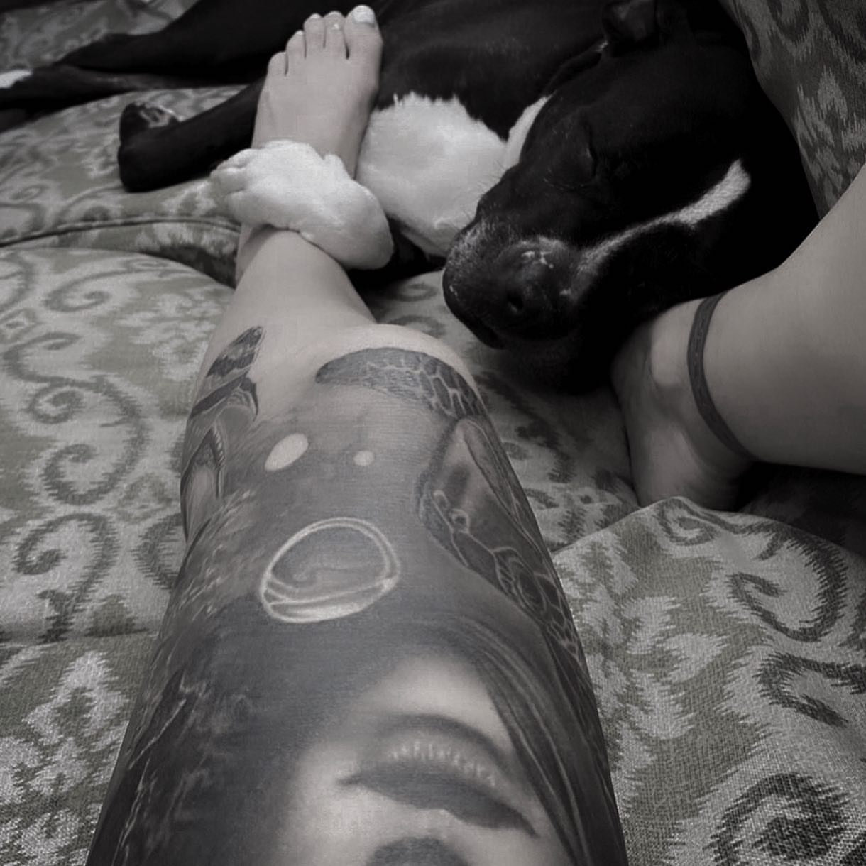Astronaut and moon black and grey tattoo on the upper arm by Gabriel Londis