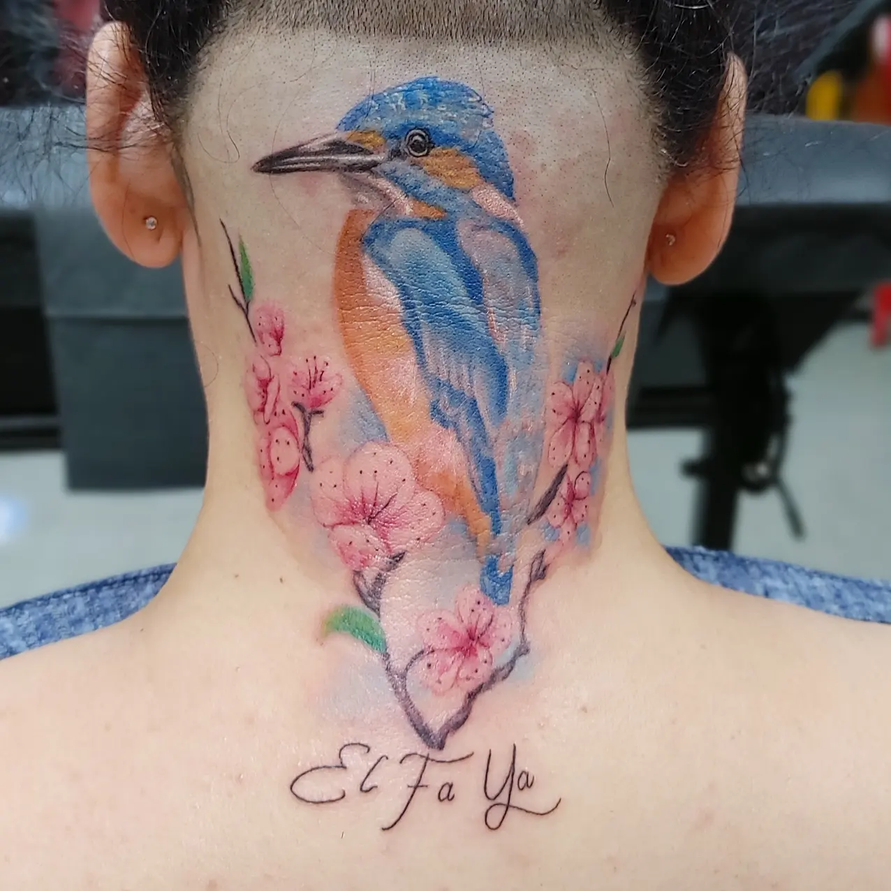 Bird and blossoms realism tattoo on the neck by Mike Stamper