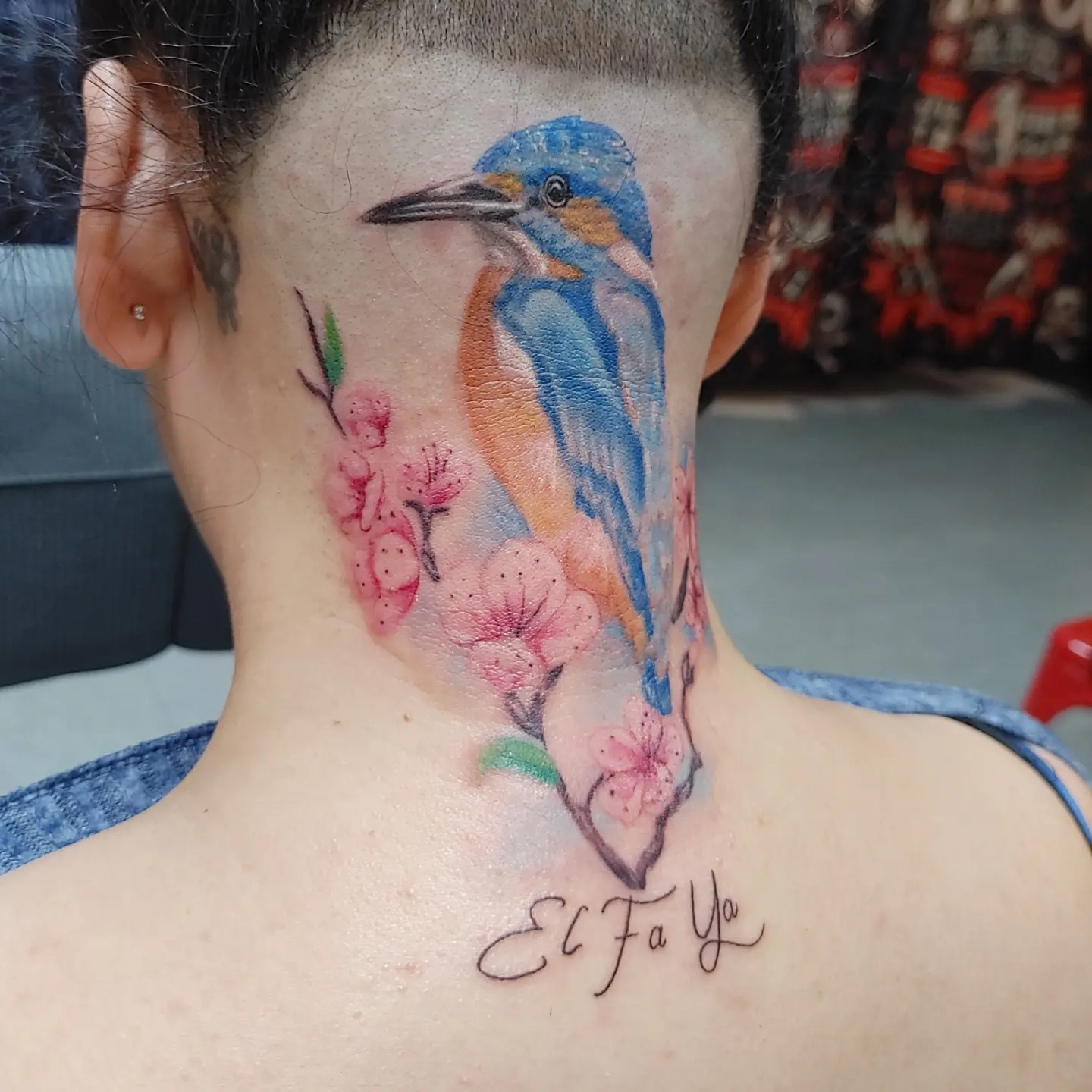 Kingfisher and blossoms realism tattoo on the neck by Mike Stamper