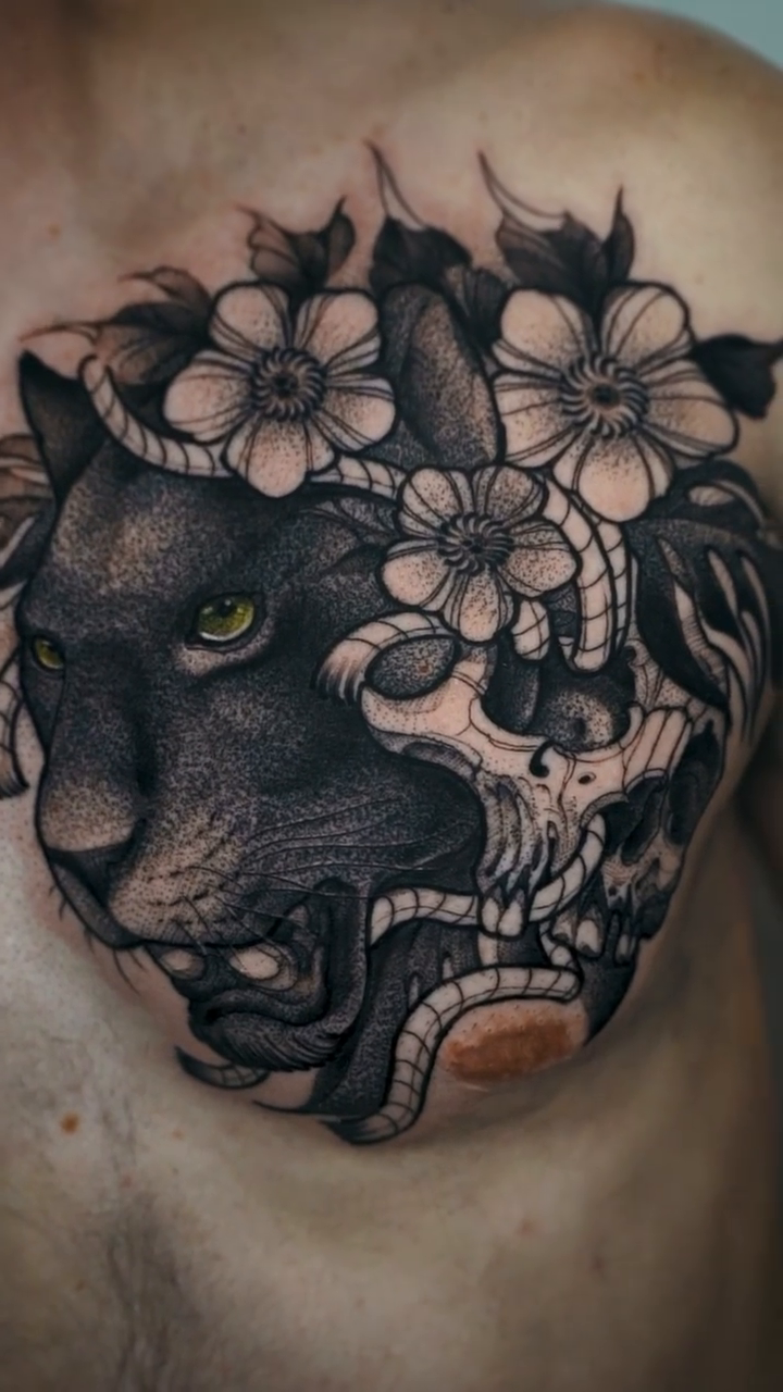 Panther head with skull and flowers dark realism tattoo by Manuel Alejandro Maldonado