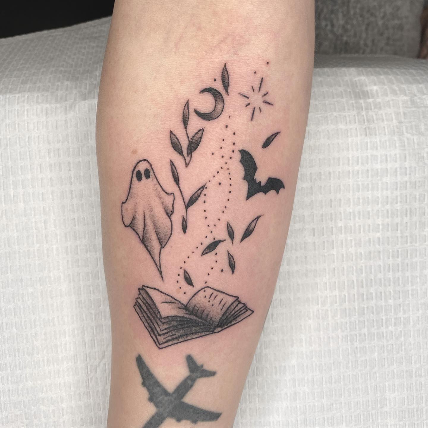 Ghost, book, bat, moon, stars dotwork tattoo on the forearm by Ray Trombetta, Wallingford, Connecticut