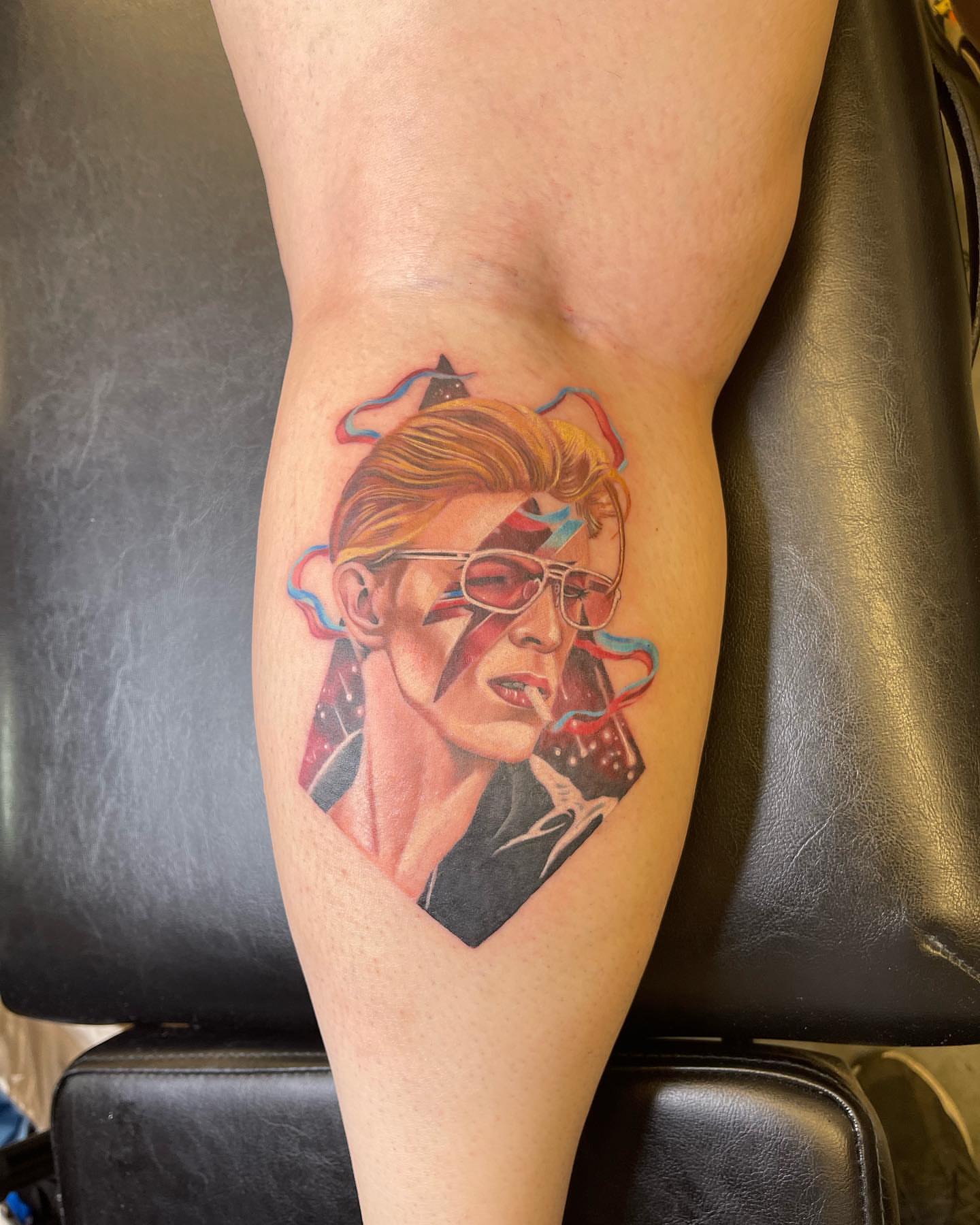 David Bowie realism tattoo on the thigh by Paul Hicks