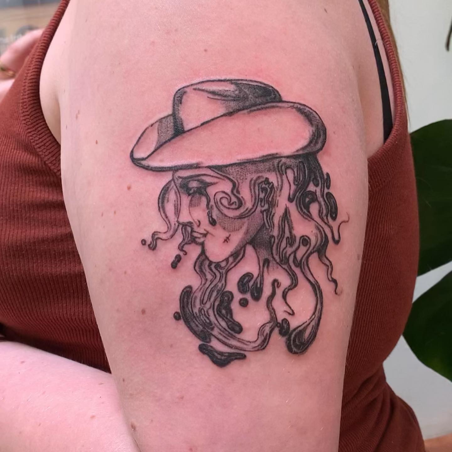 Woman wearing hat dotwork tattoo on the shoulder by ᴀmb⃘er