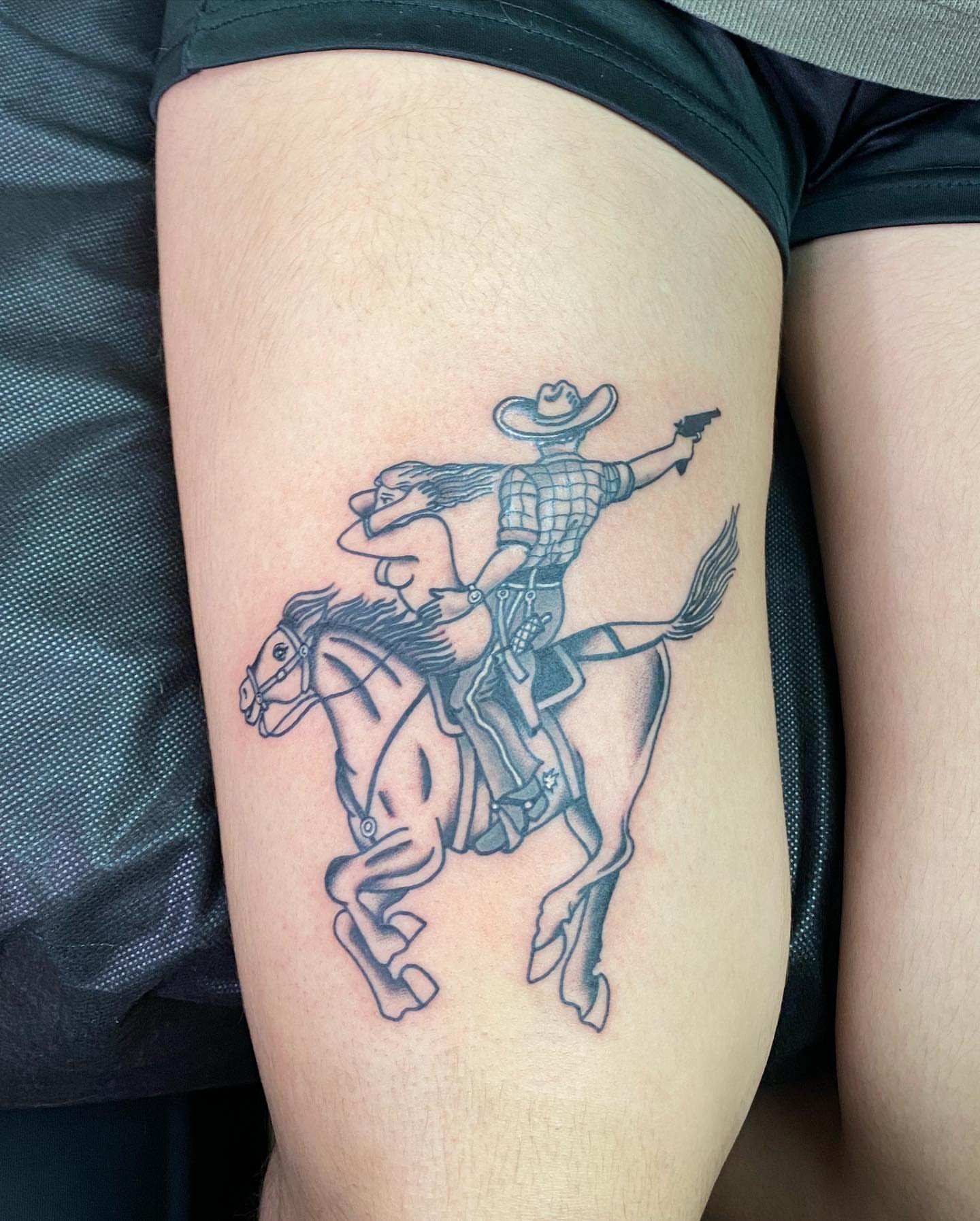 Cowboy on horse black and grey tattoo on the thigh by Payton Prentice