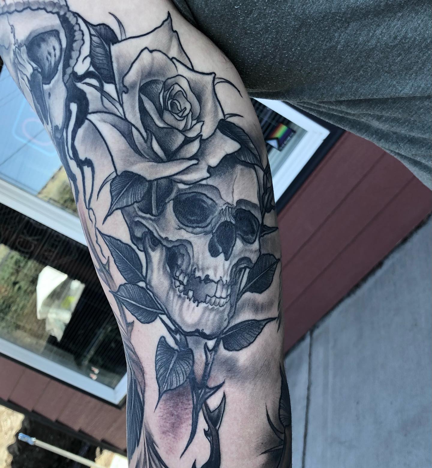 Skull and roses realism tattoo on the forearm by Aaron Borden